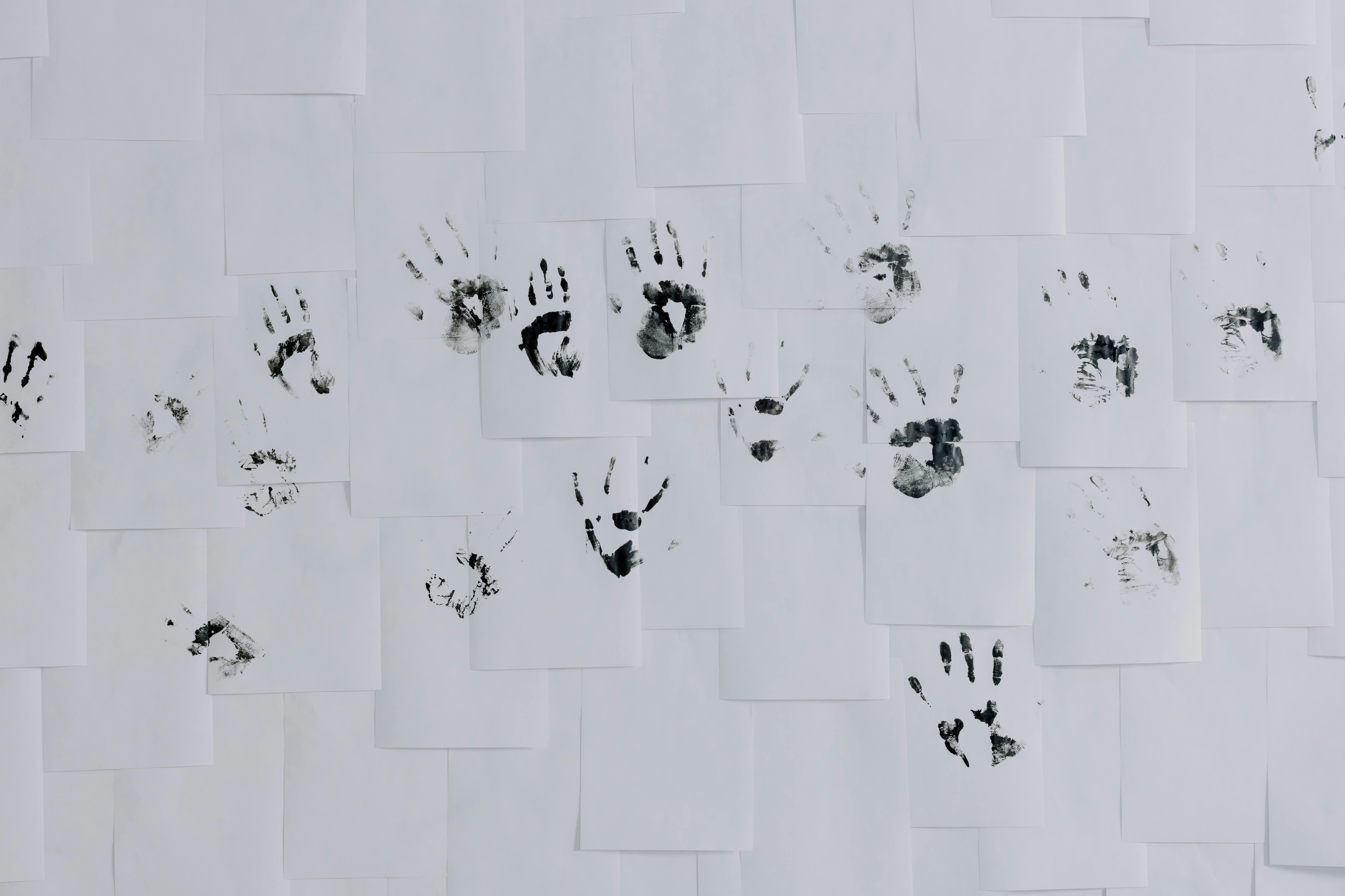 Hand Prints on White Papers Posted on a Wall