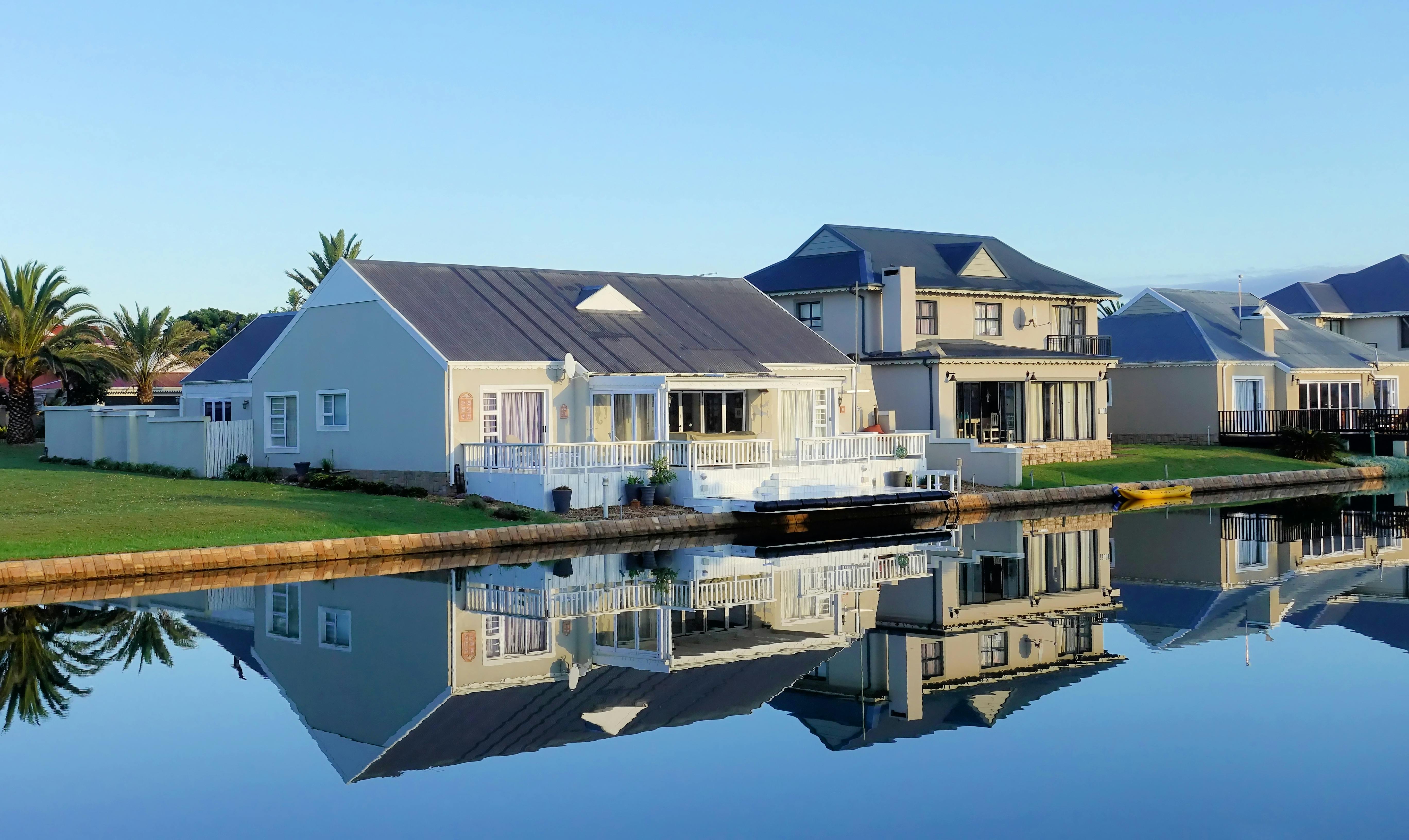 White Single-story Houses Beside Body of Water