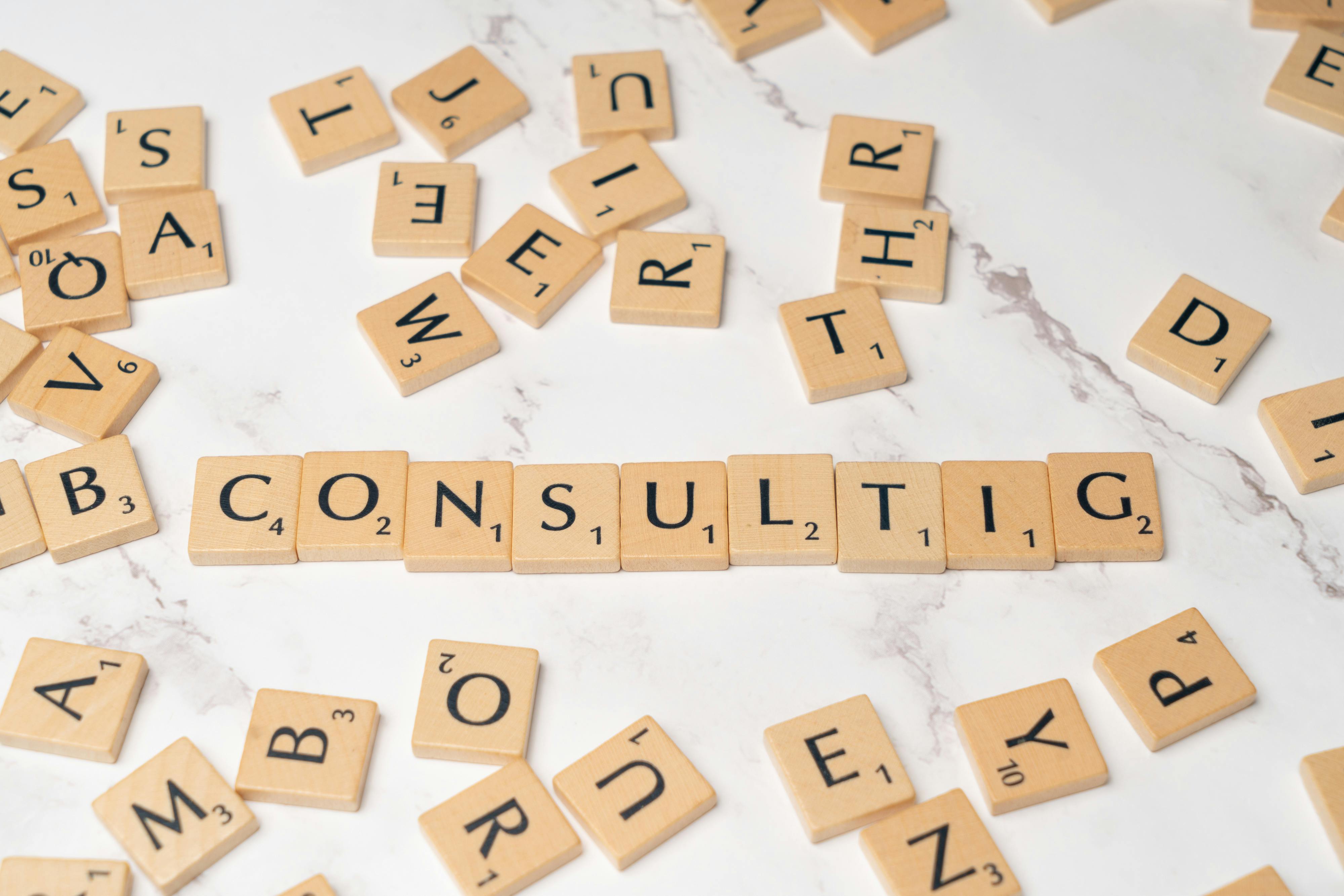 Business concepts illustrated through scrabble tiles forming the word "consulting"