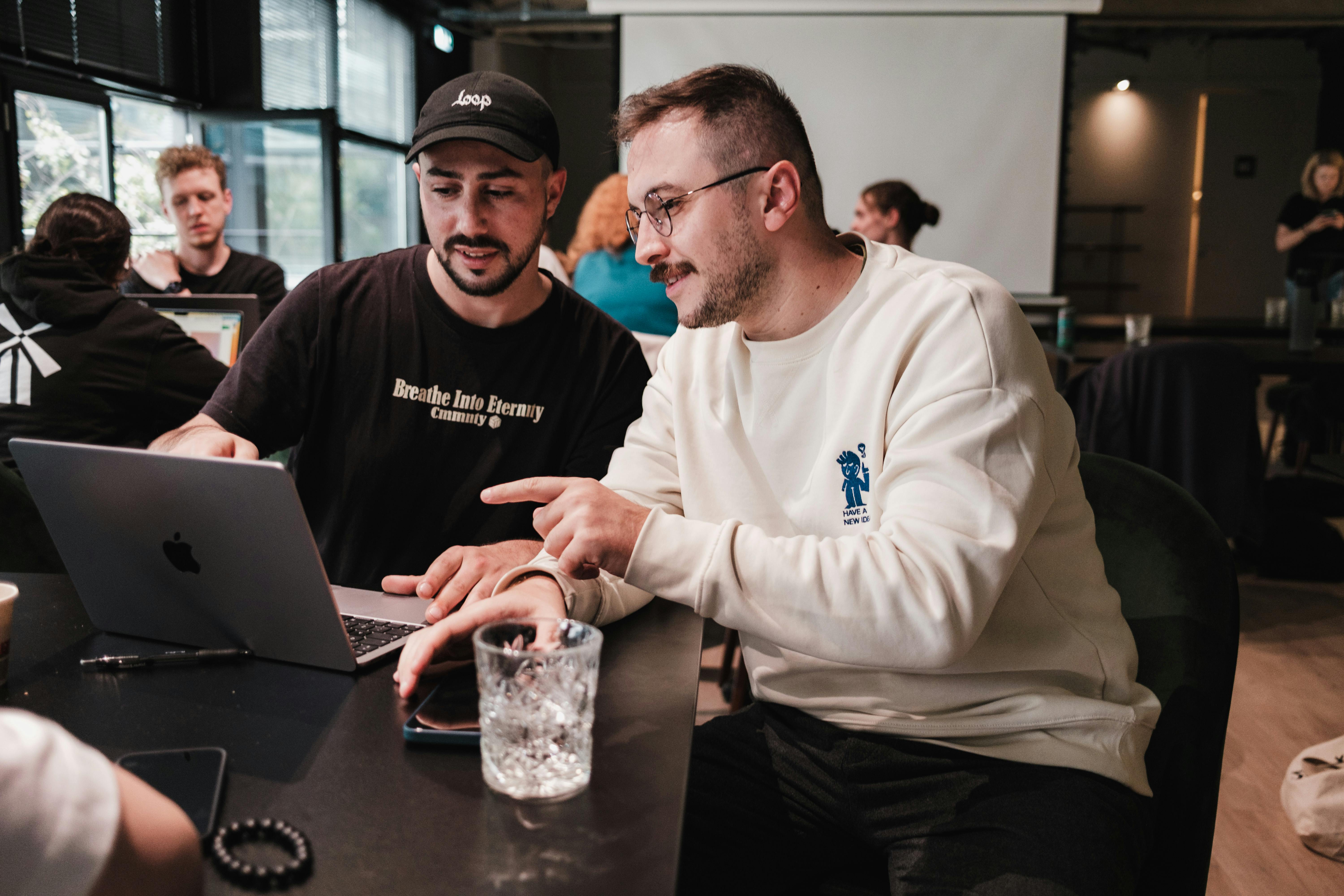 Men Sitting with Laptop and Working at Cafe