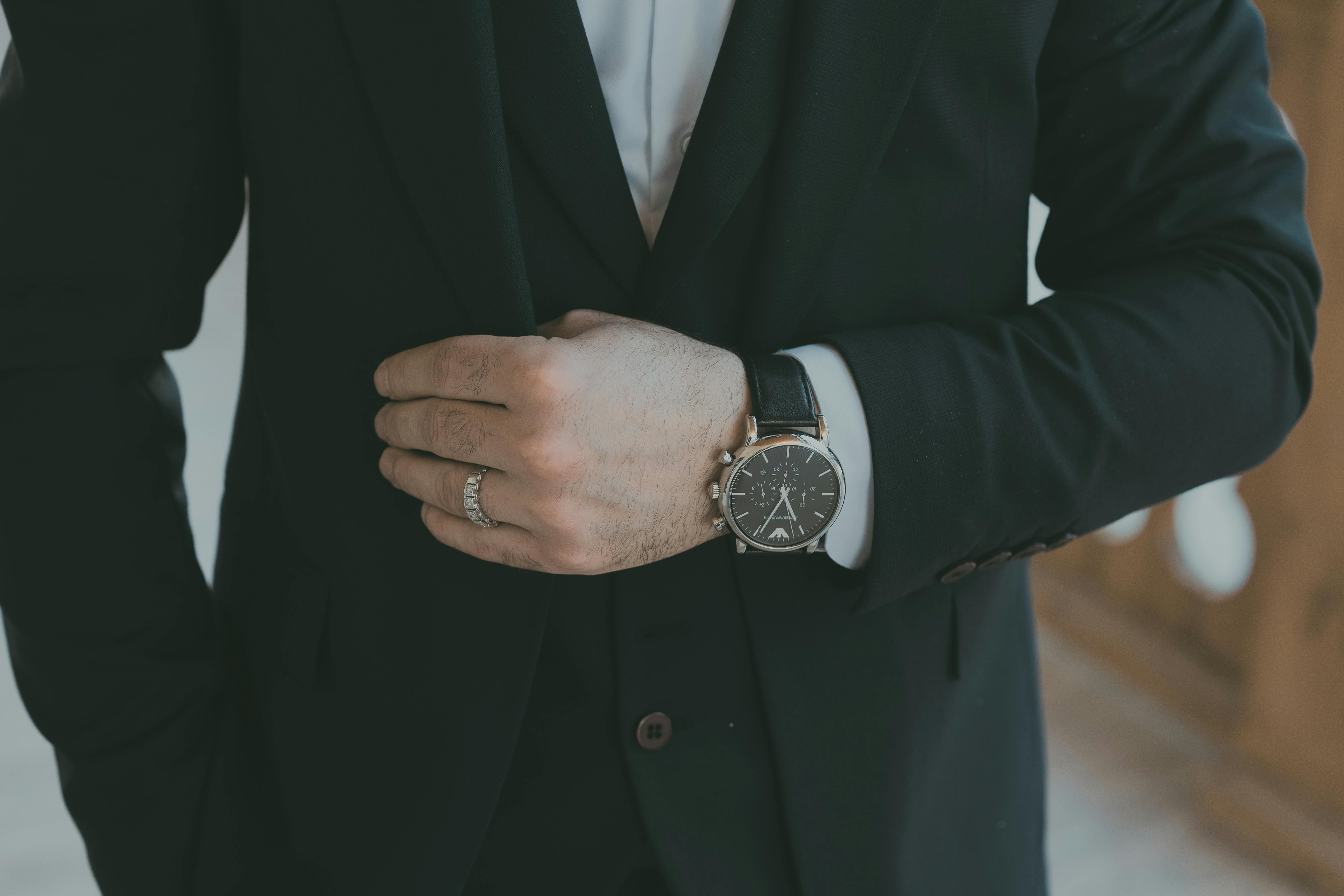 Man in Tree Part Suit with Wristwatch