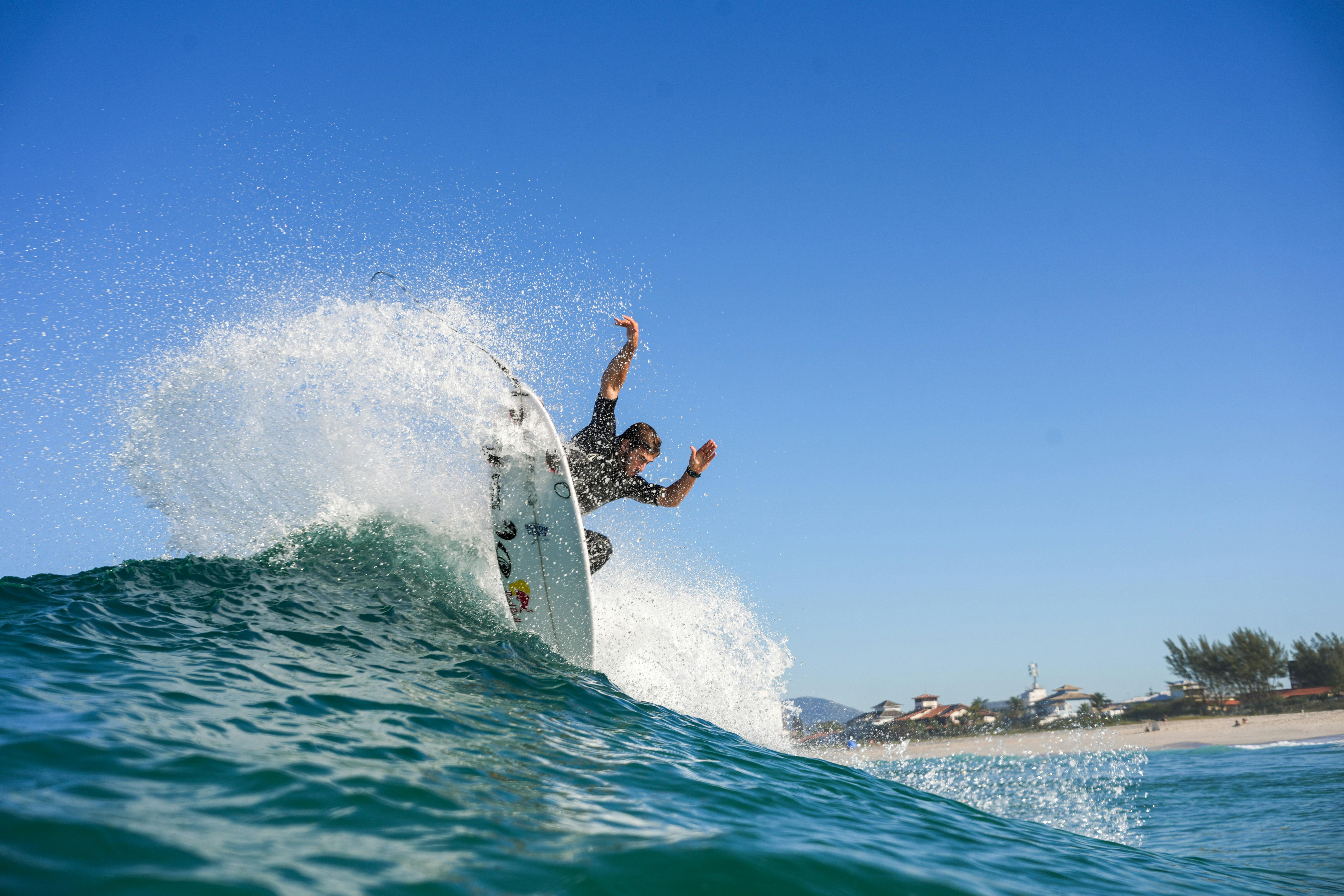 Surfer on Wave on Sea Shore