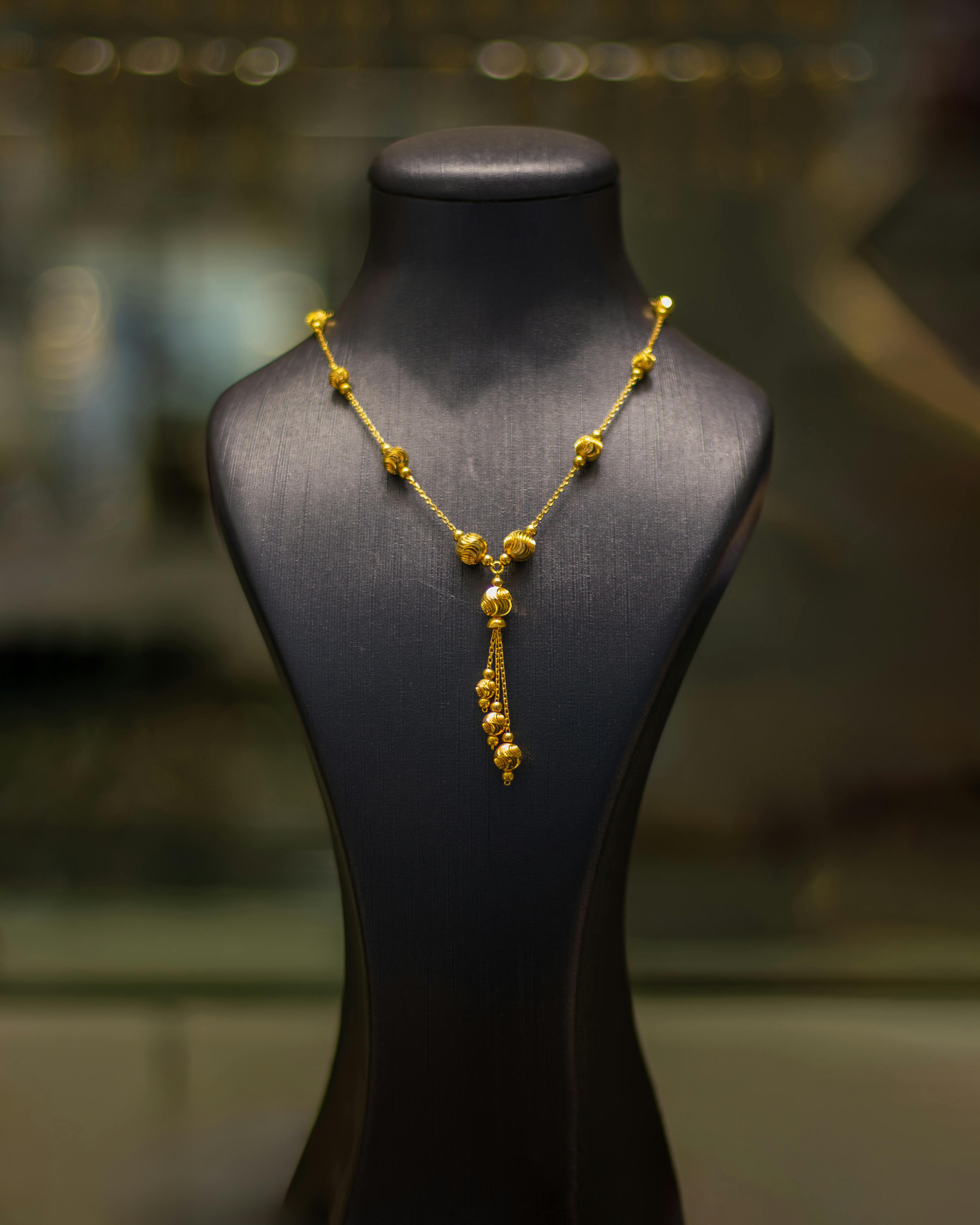 Elegant Gold Necklace on Display Mannequin