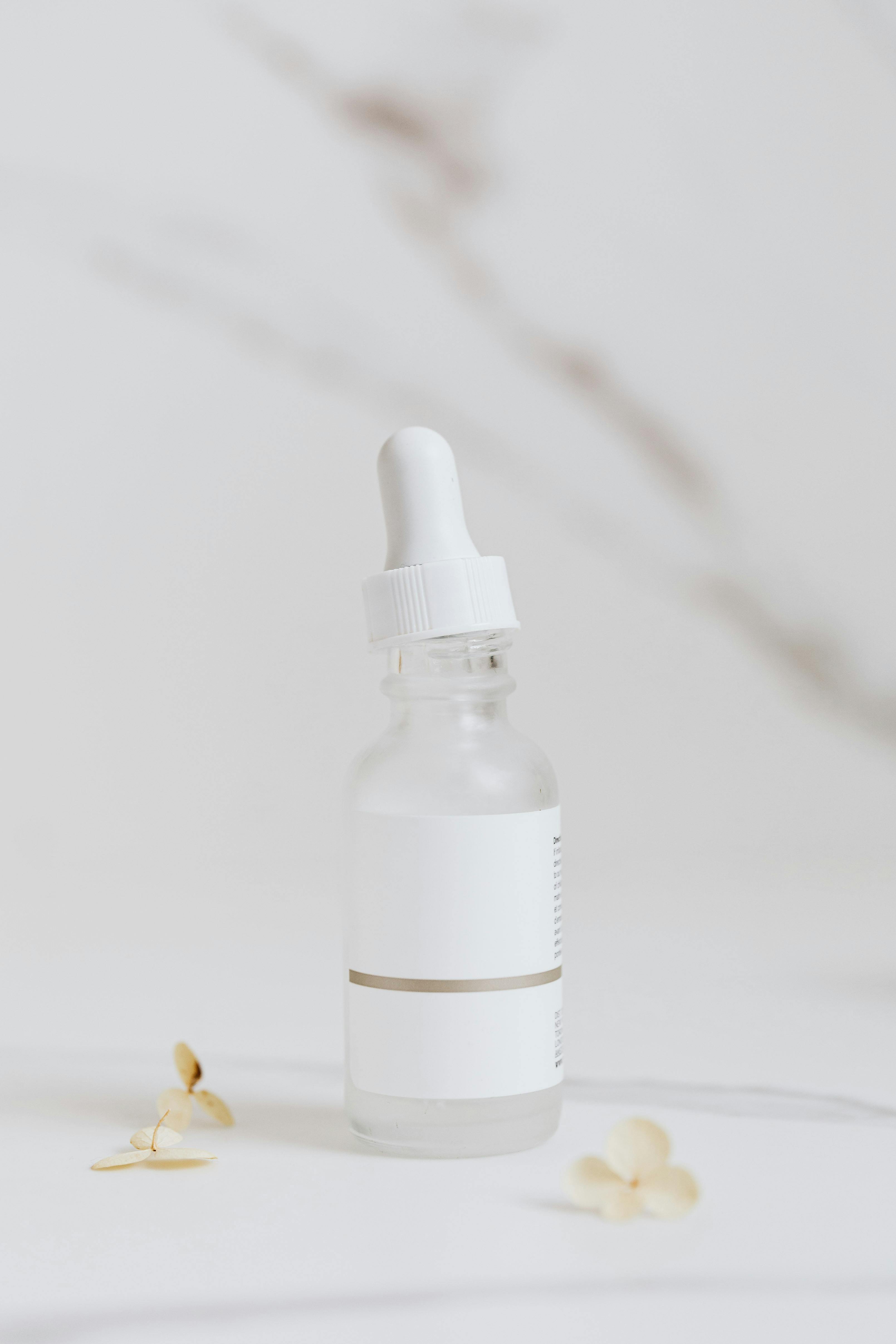 White Serum Bottle on White Surface 