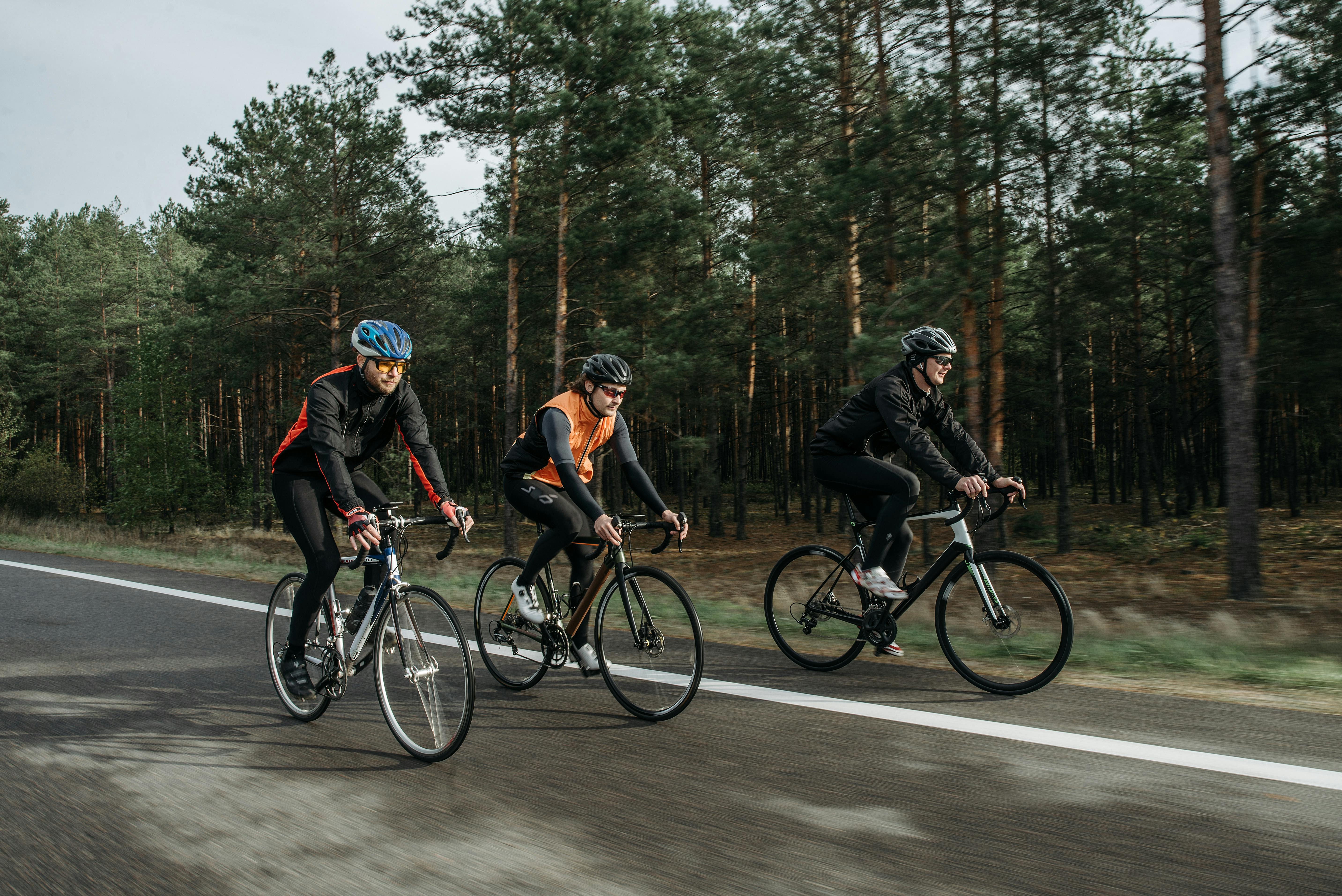 Group of People Riding Bicycle on Road