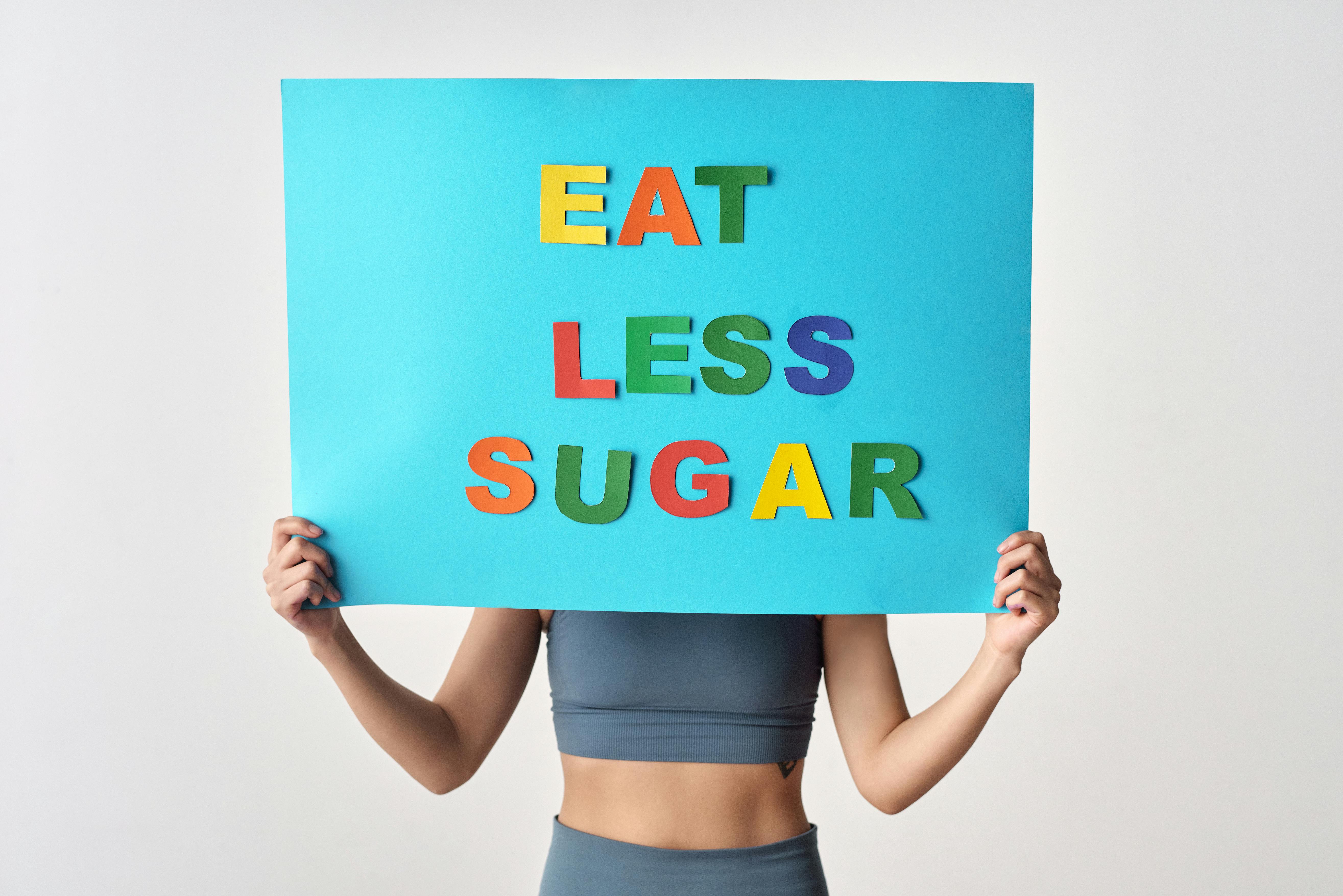 Person Holding a Blue Poster with Message