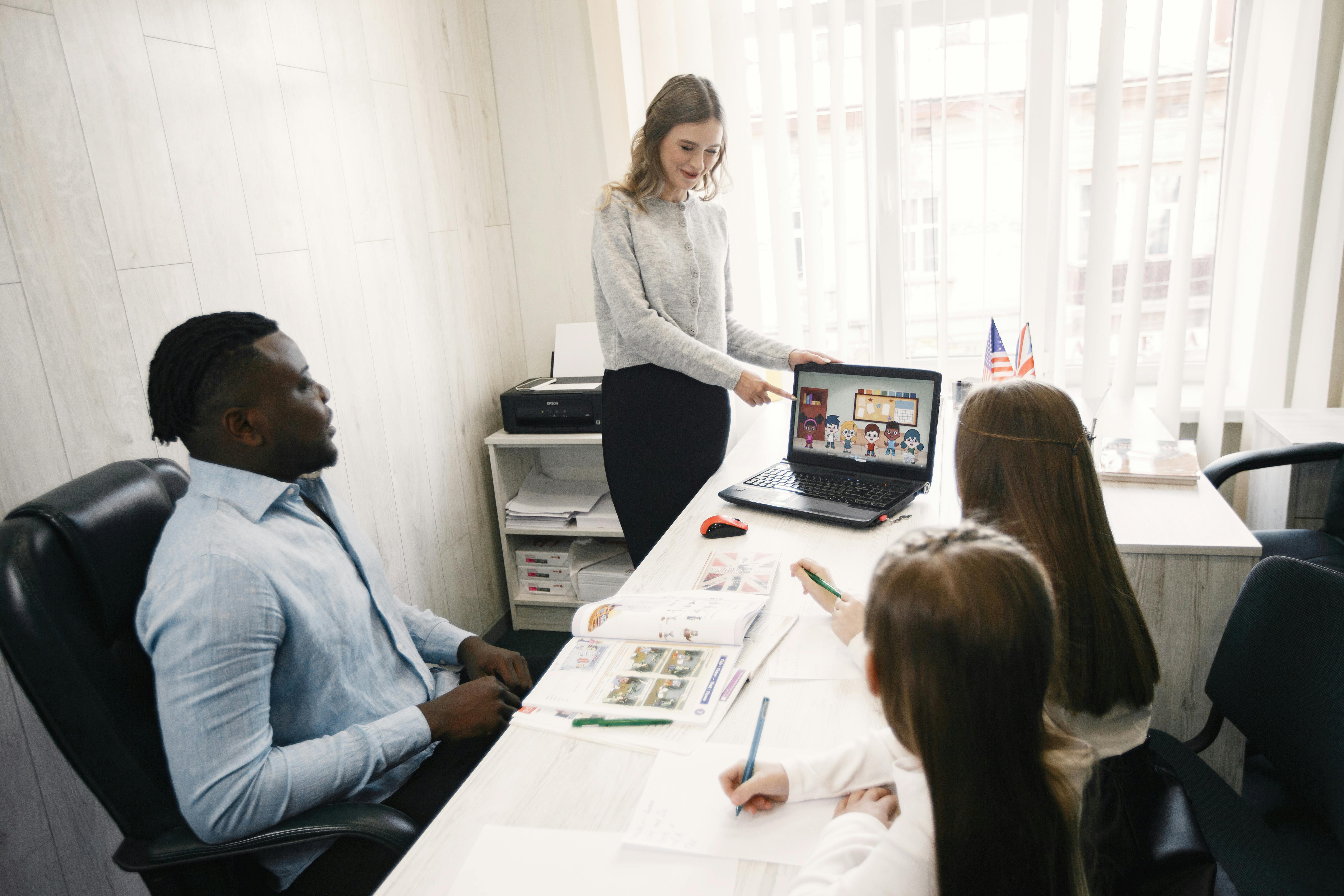 Woman Pointing Image on Laptop Screen