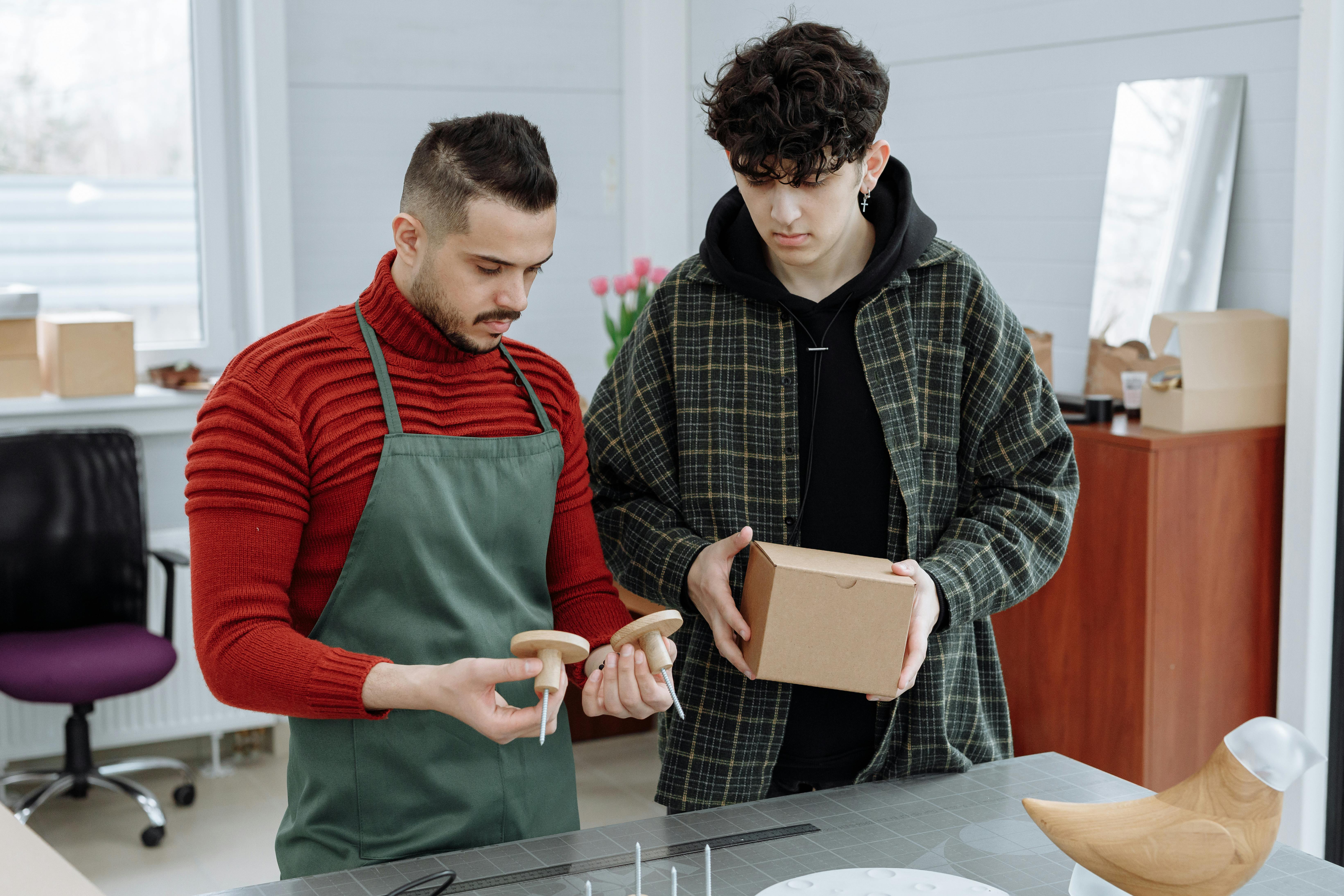 Men Looking at a Product and Its Packaging