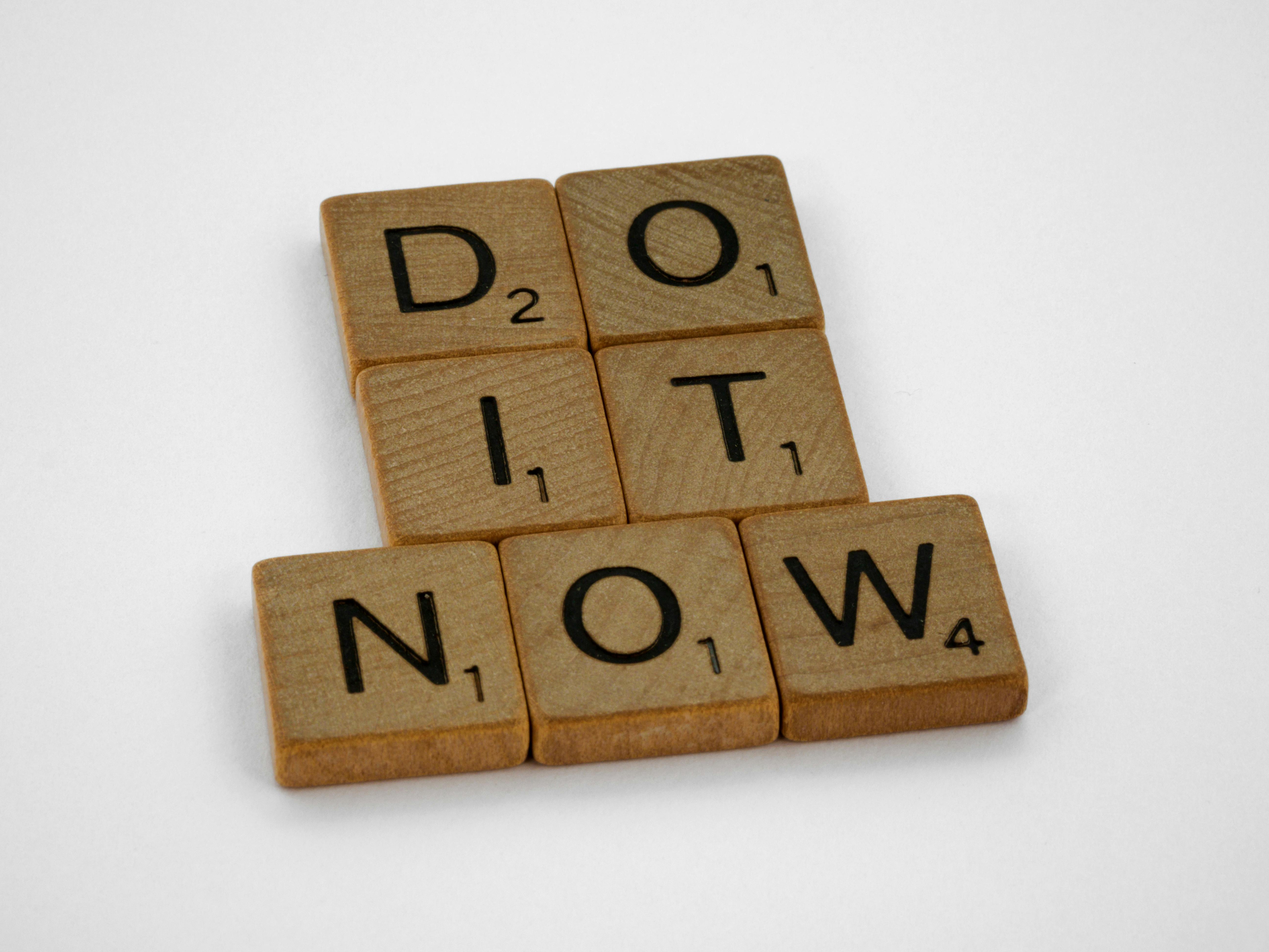 Brown Wooden Scrabble Tiles on White Background