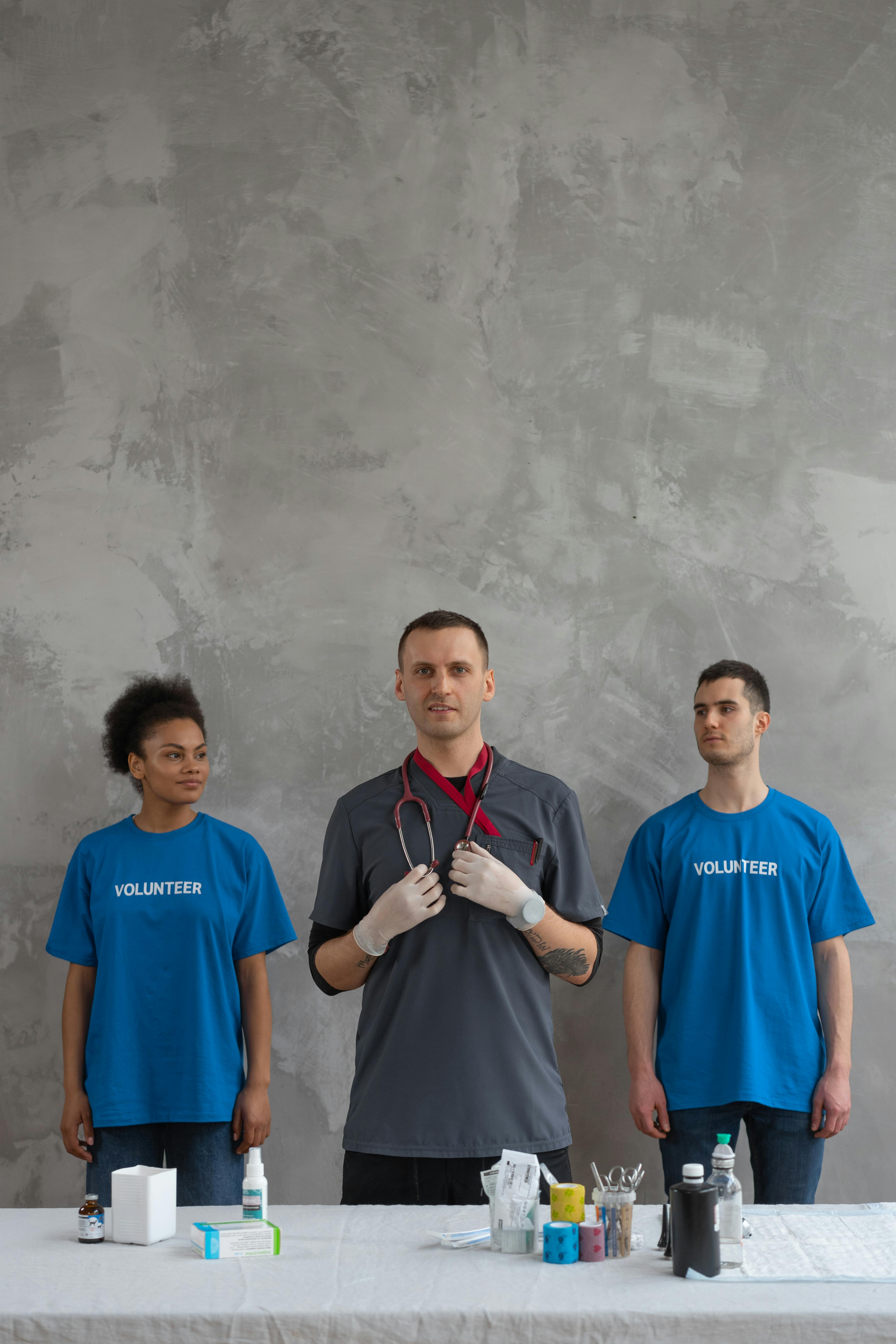 Man in Blue Crew Neck T-shirt Standing Beside Woman in Blue Crew Neck T-shirt