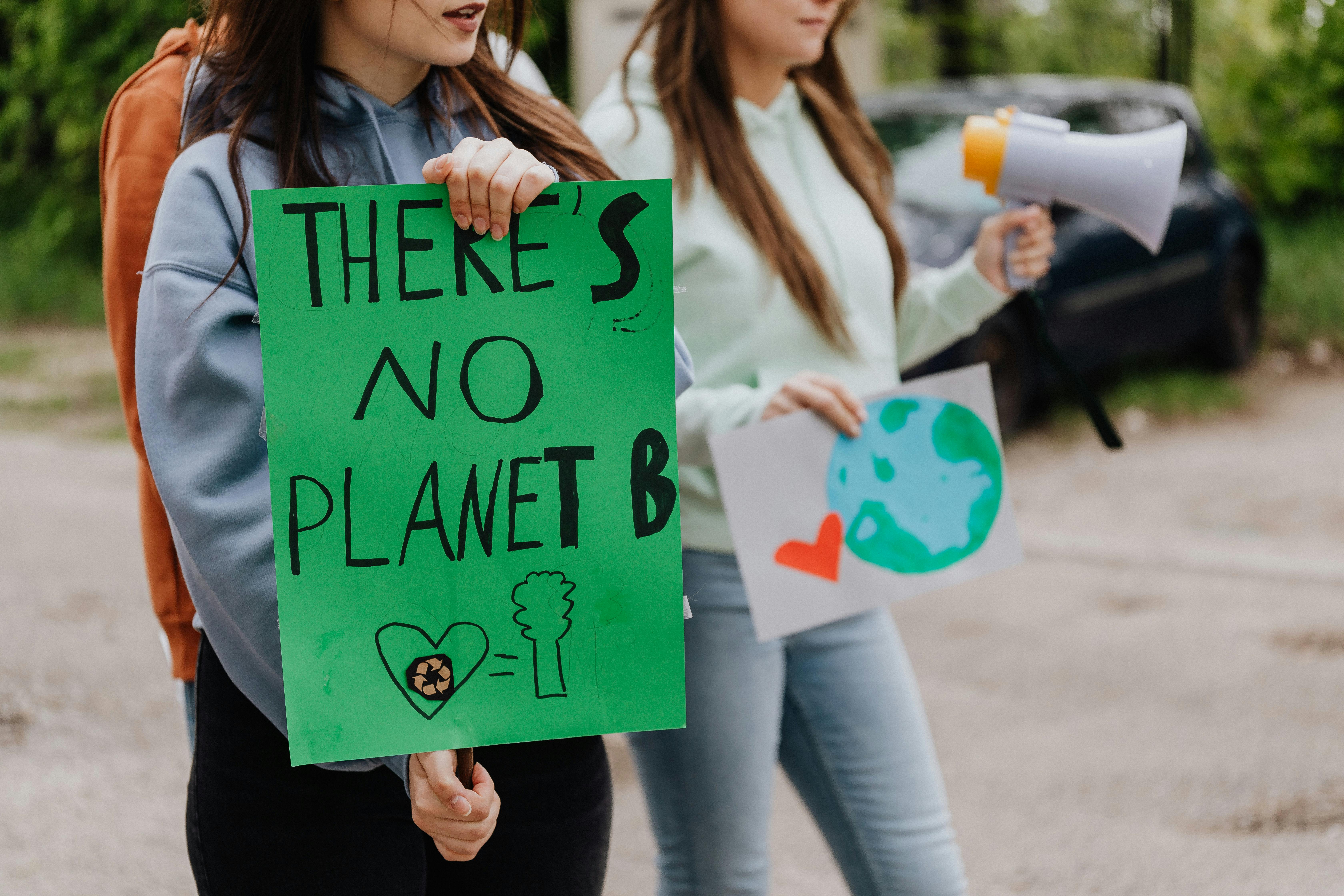 Woman holding a Green Placard