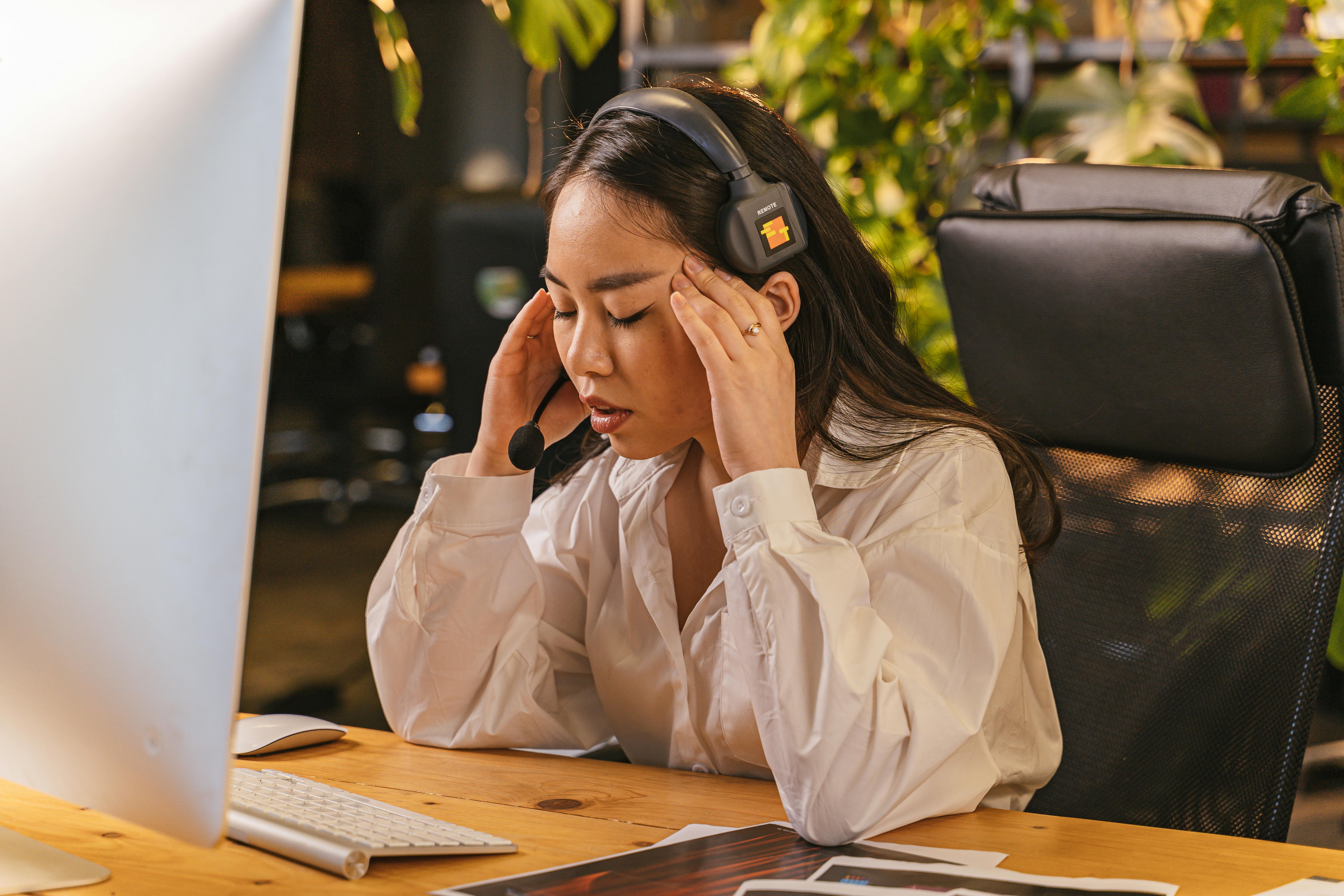 Tired Woman at a Desk in an Office