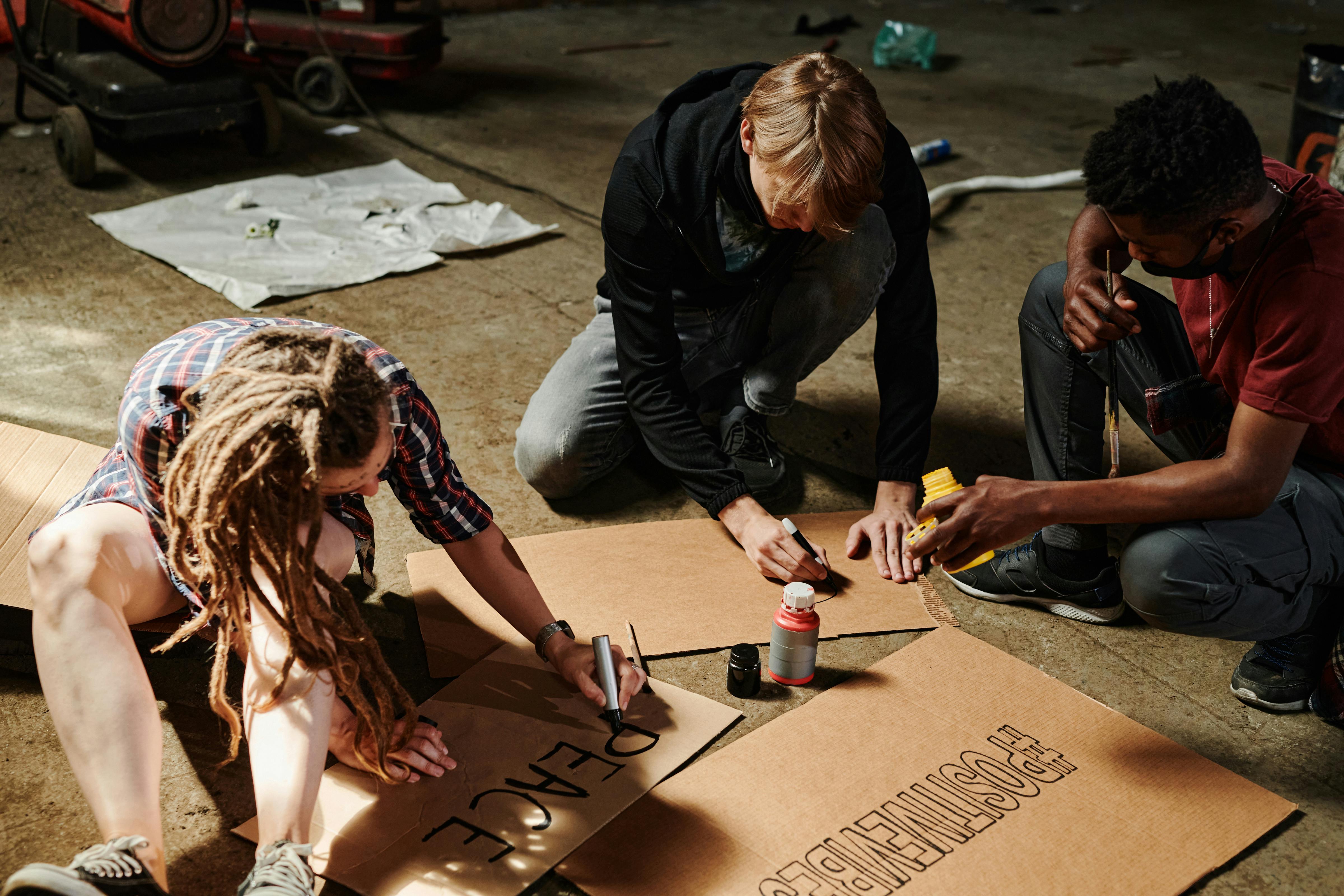 People Writing on Cardboards