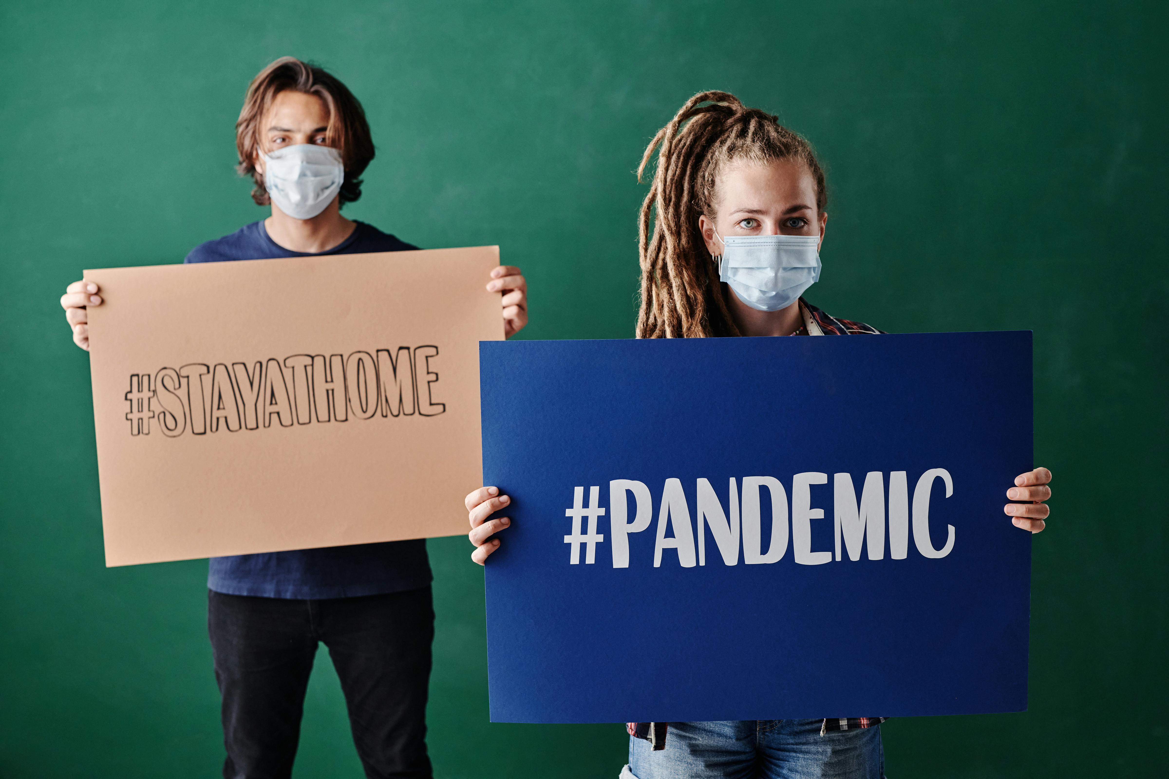 A Man and Woman Holding Banners