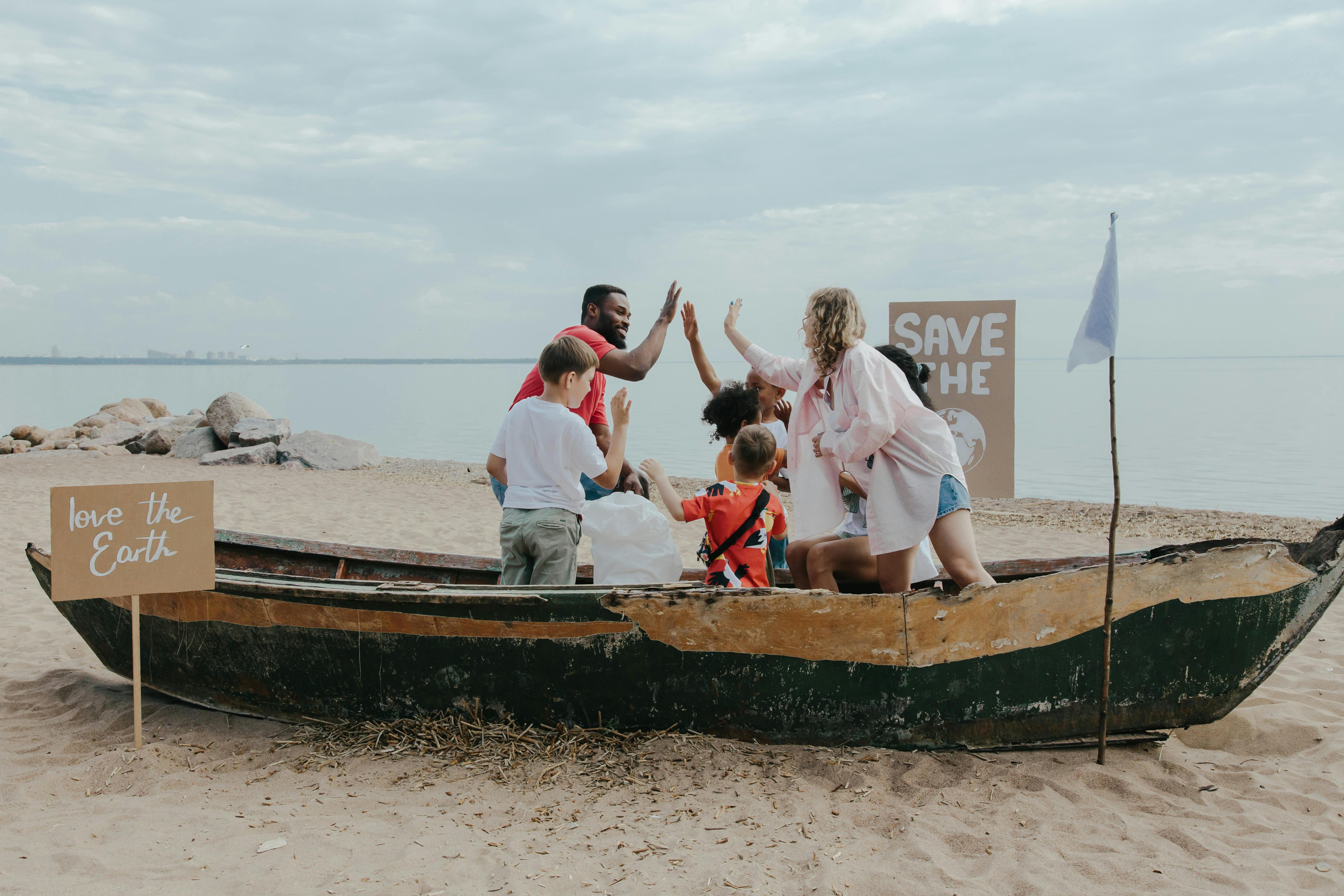 Group of People in a Boat on Beach Sand Doing High Five