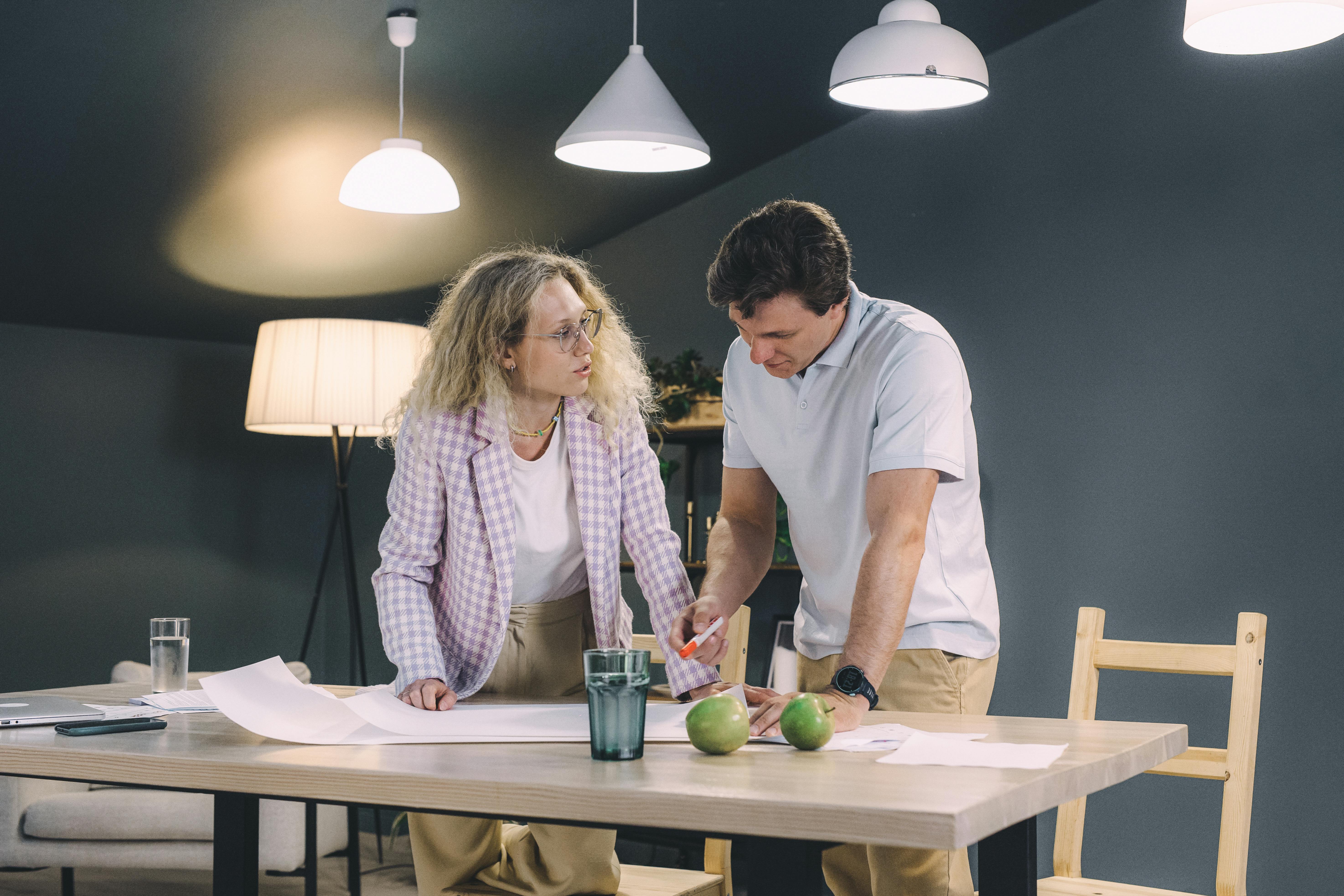 Man and Woman Standing at the Table