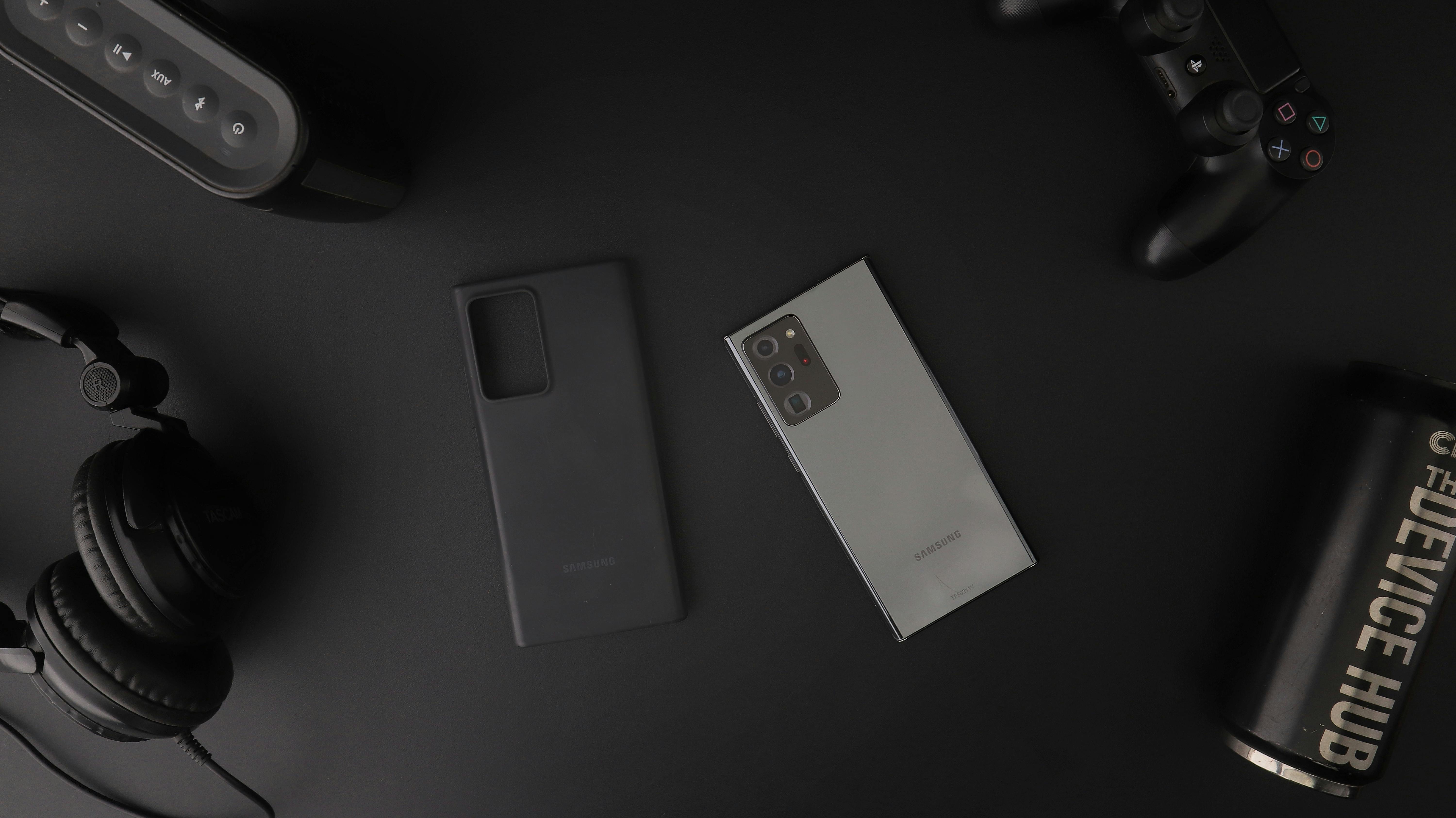 Phone and Other Devices on Black Table