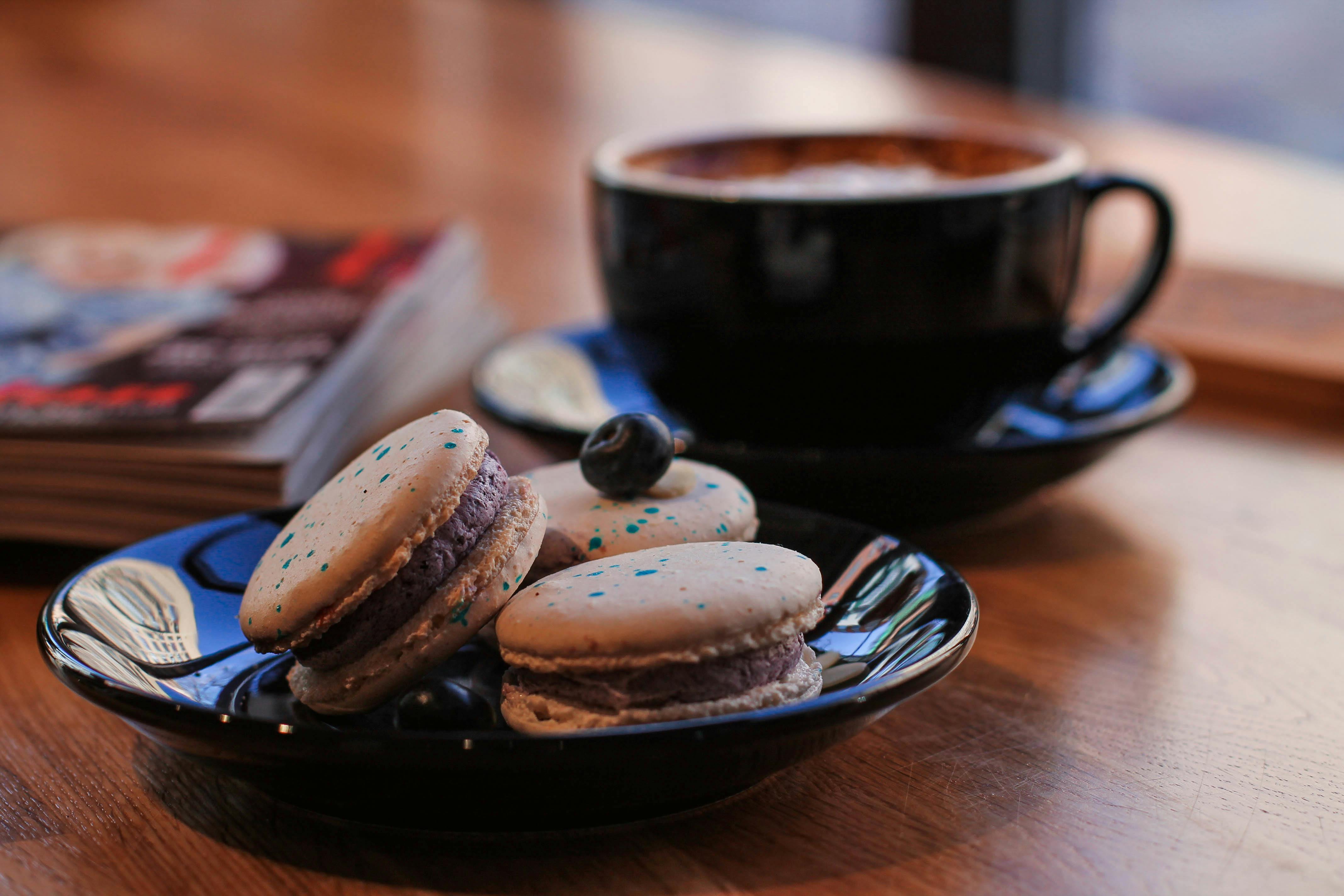 French Macarons on Black Saucer