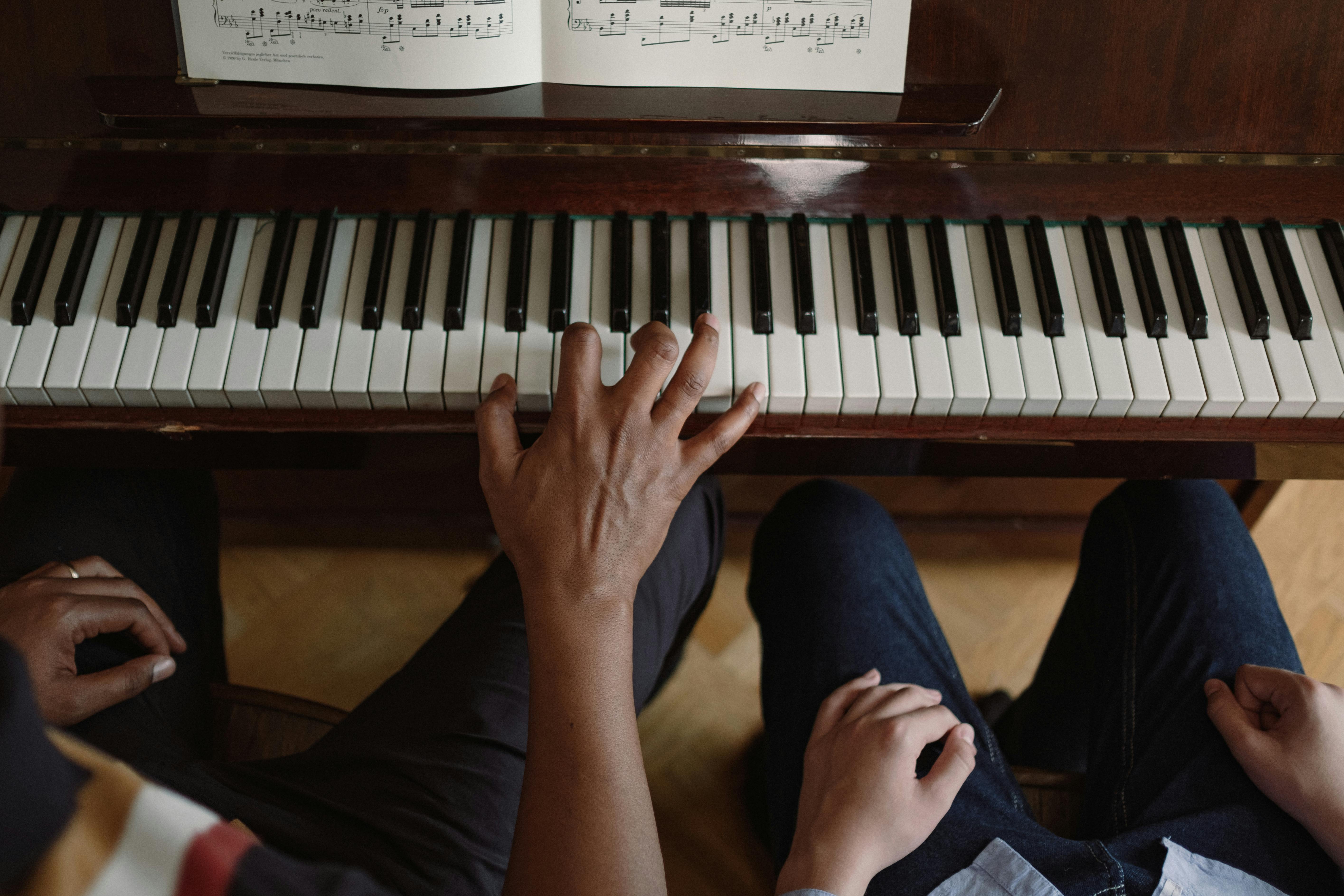 Man Teaching Boy How to Play on Piano