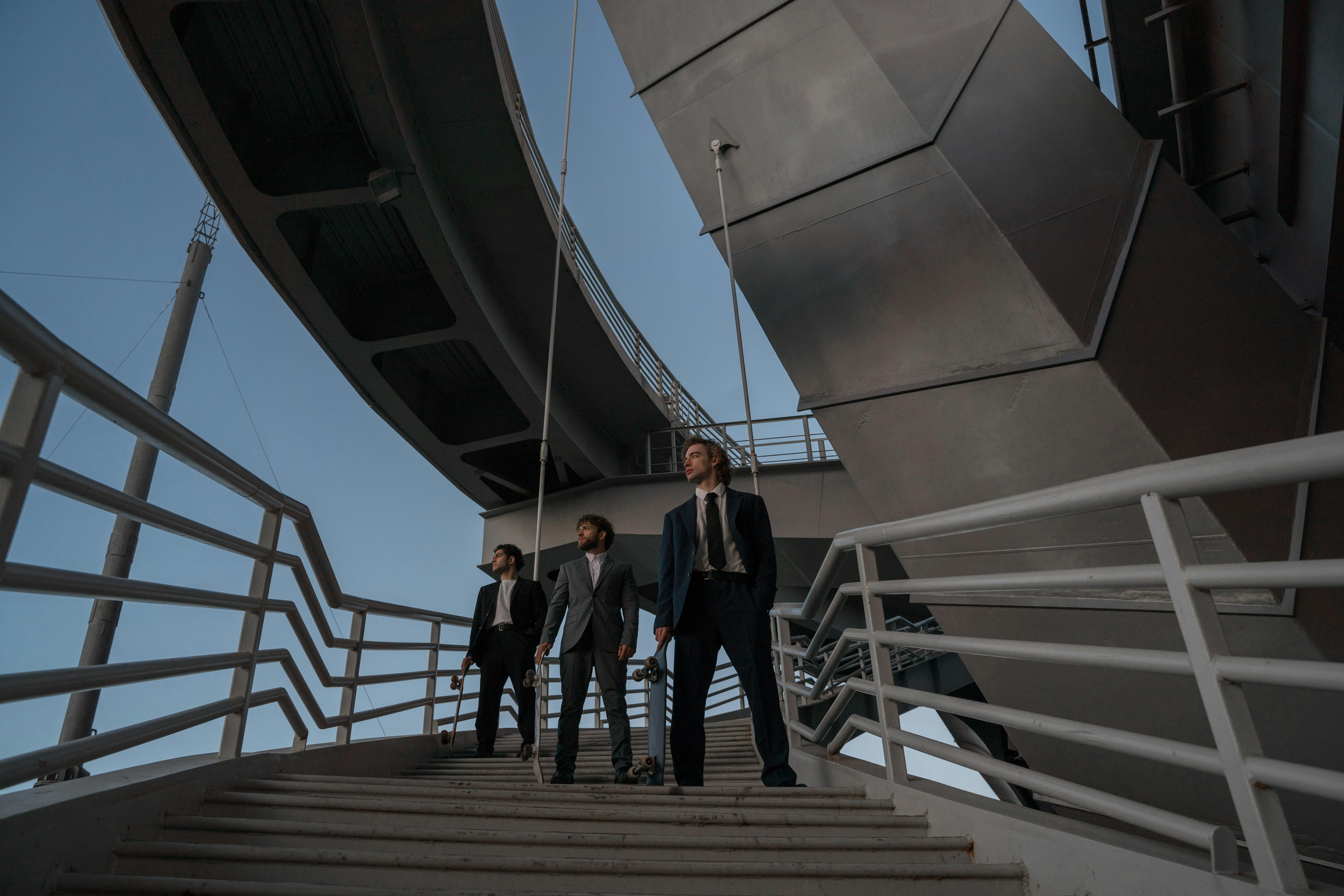 Men Wearing Suits Posing on the Stairs