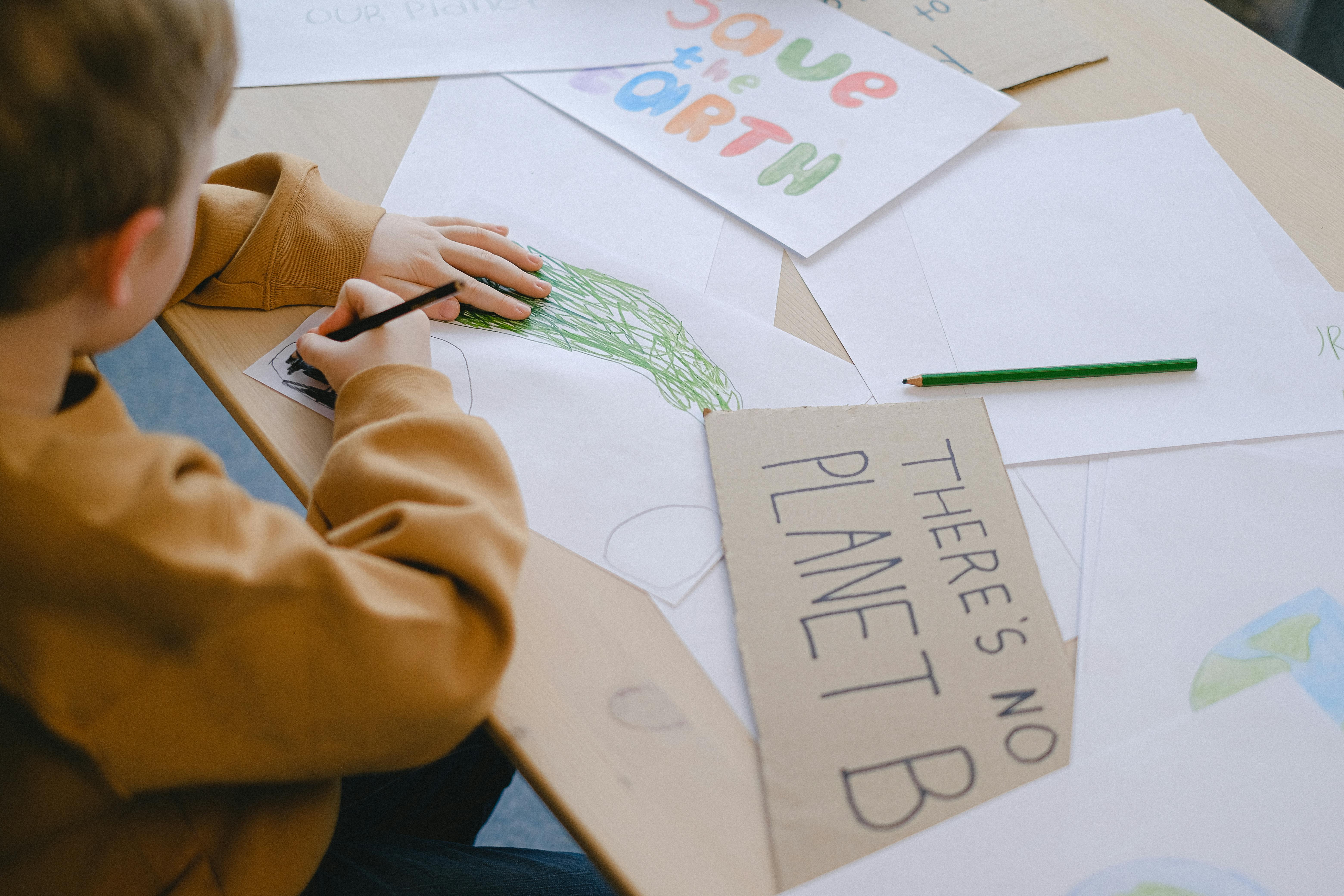 Boy Drawing at a Desk