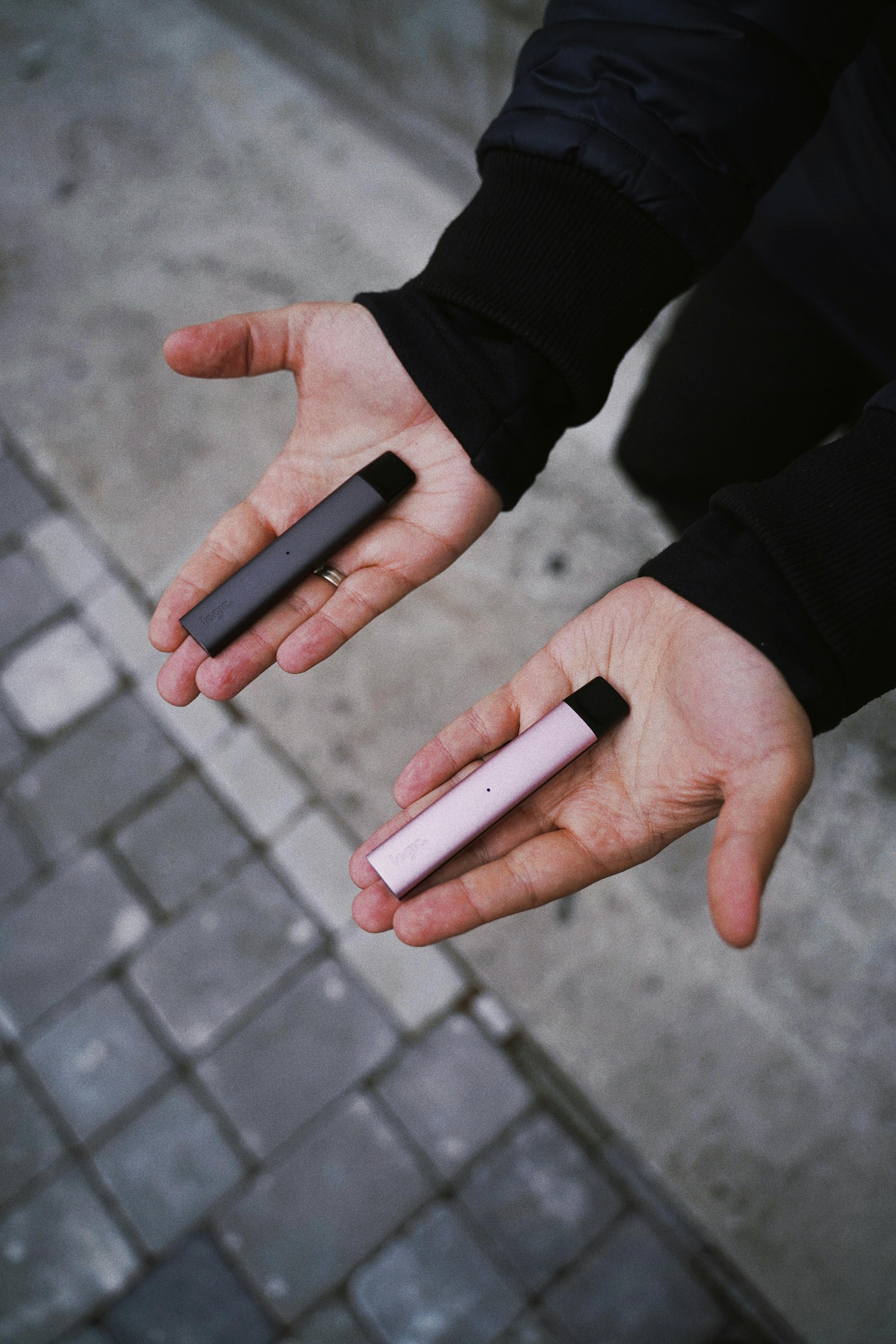 Man Holding Logic Vape Pens in Hands