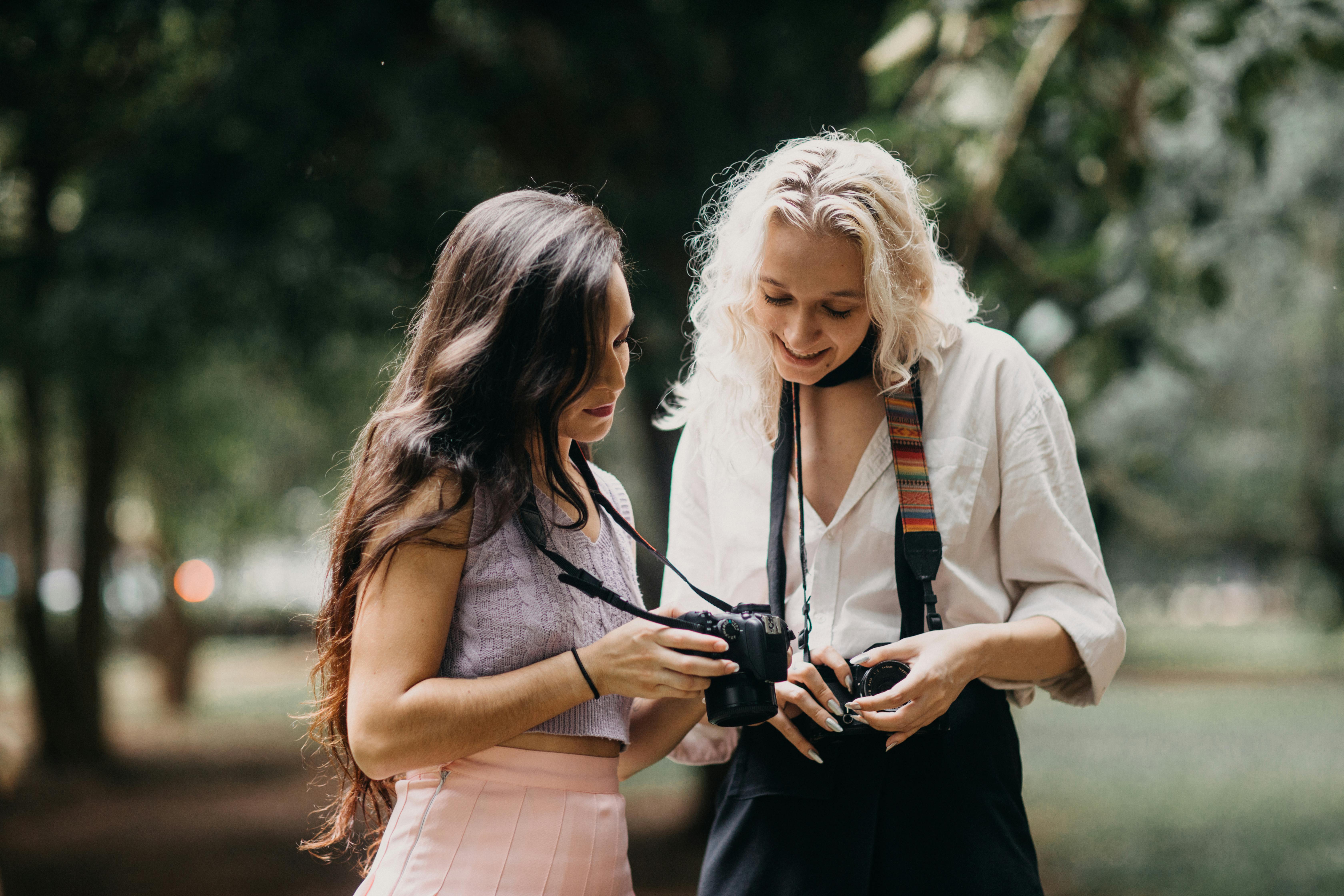 Women Looking at Photos on Camera and Smiling