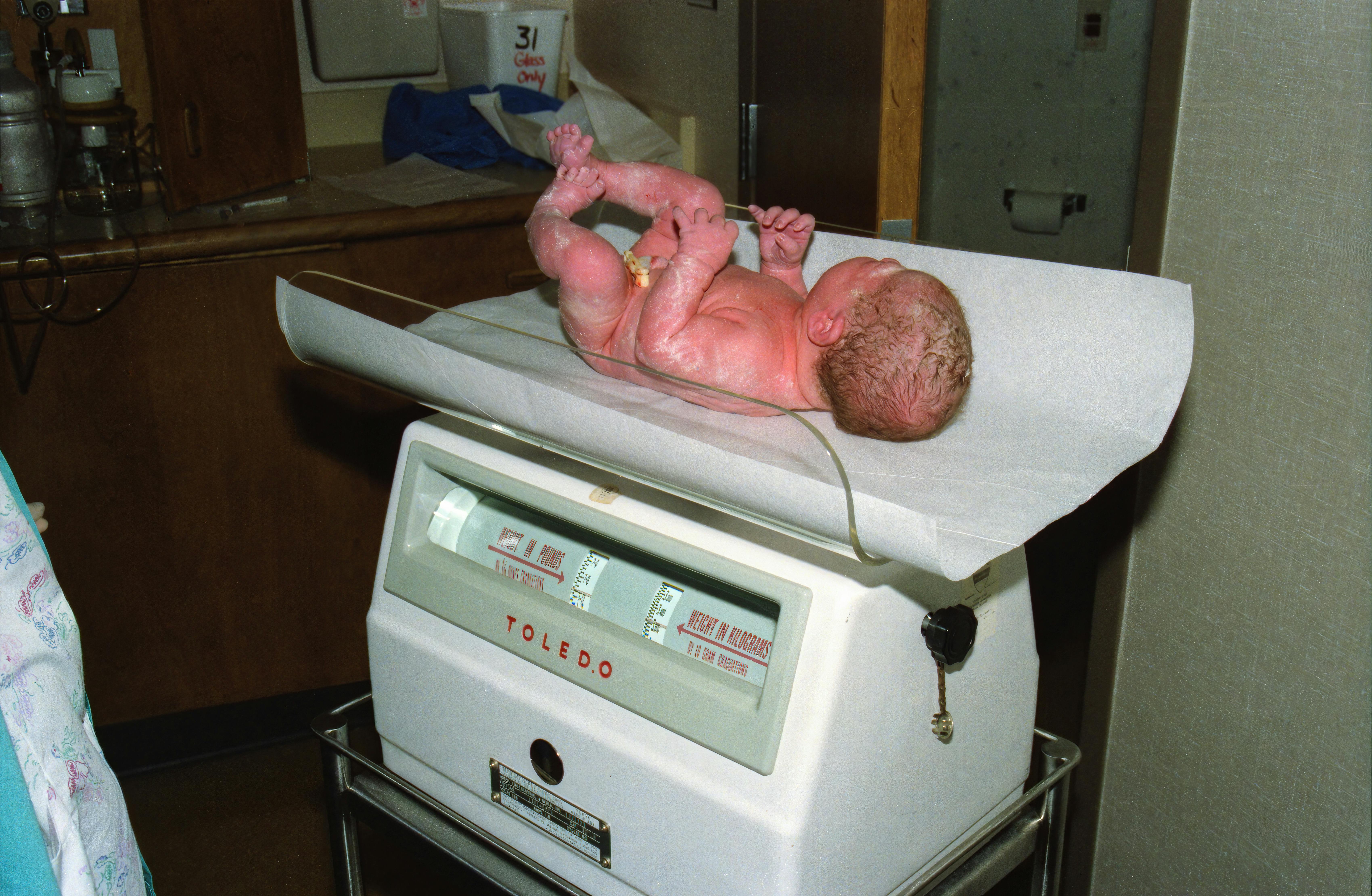 Newborn Baby on a Weighing Scale