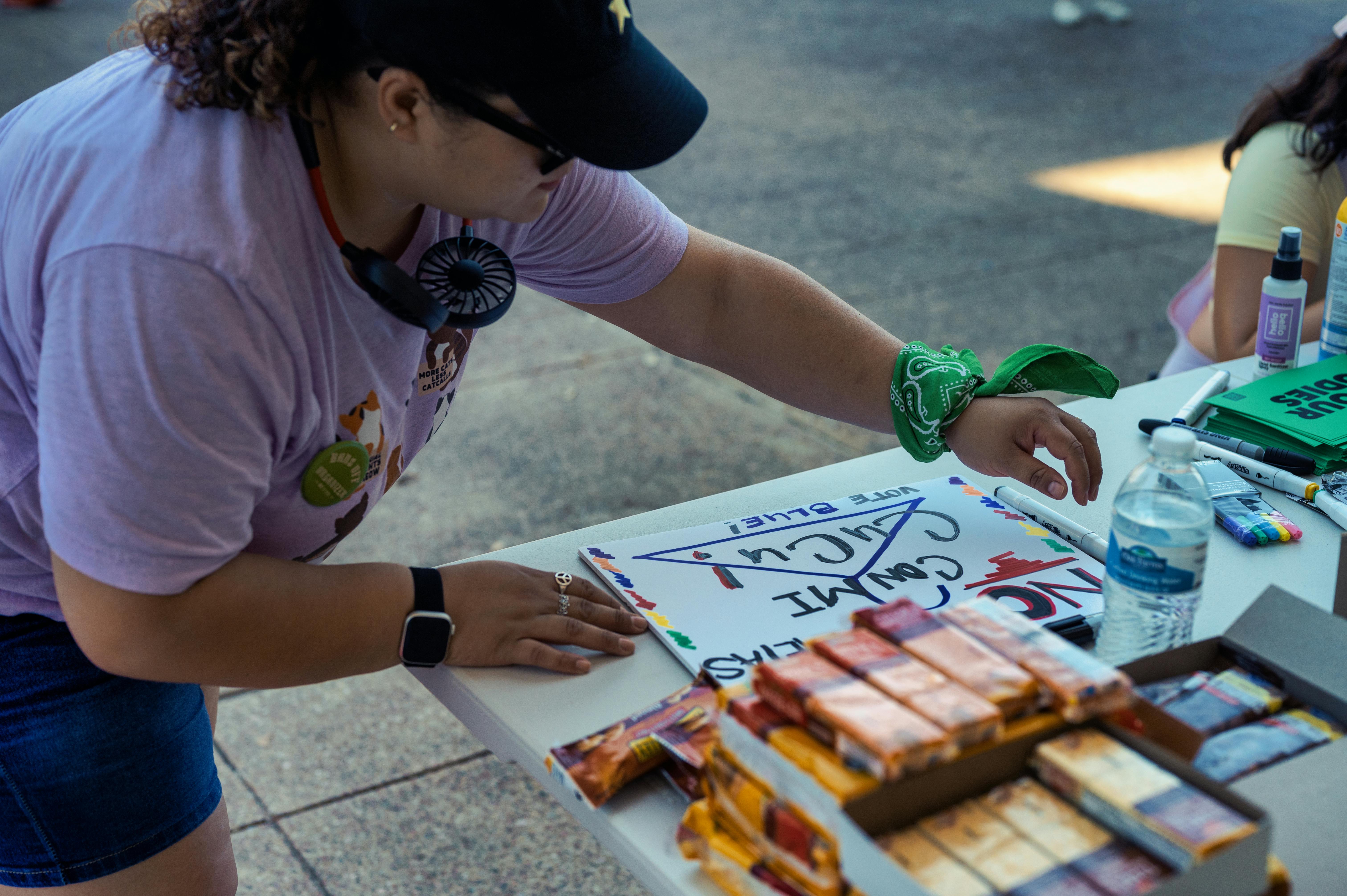 A Woman Near a Table Campaigning