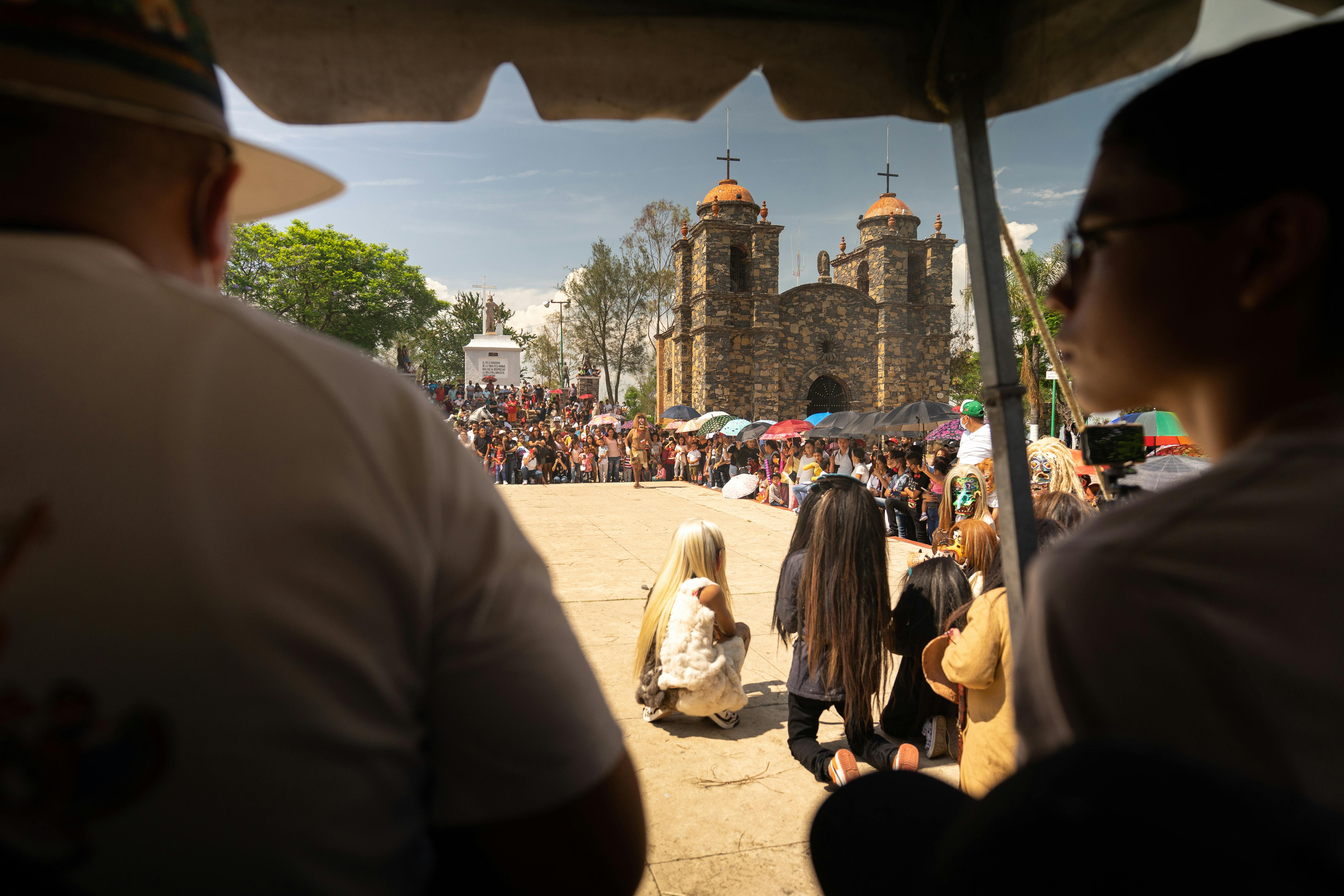 People during Performance with Church in Background