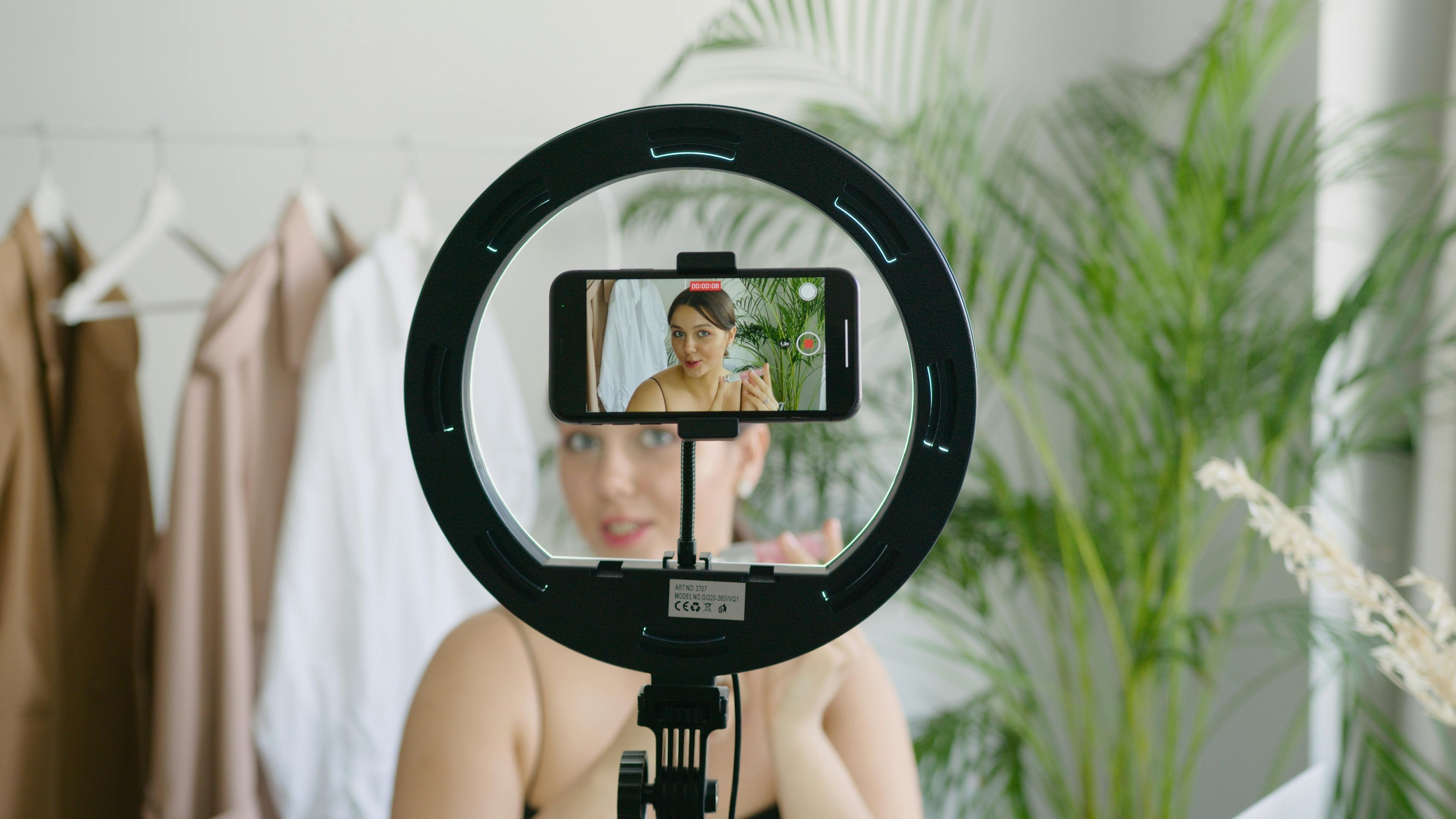 A Woman Video Recording Herself Using a Cellphone Camera