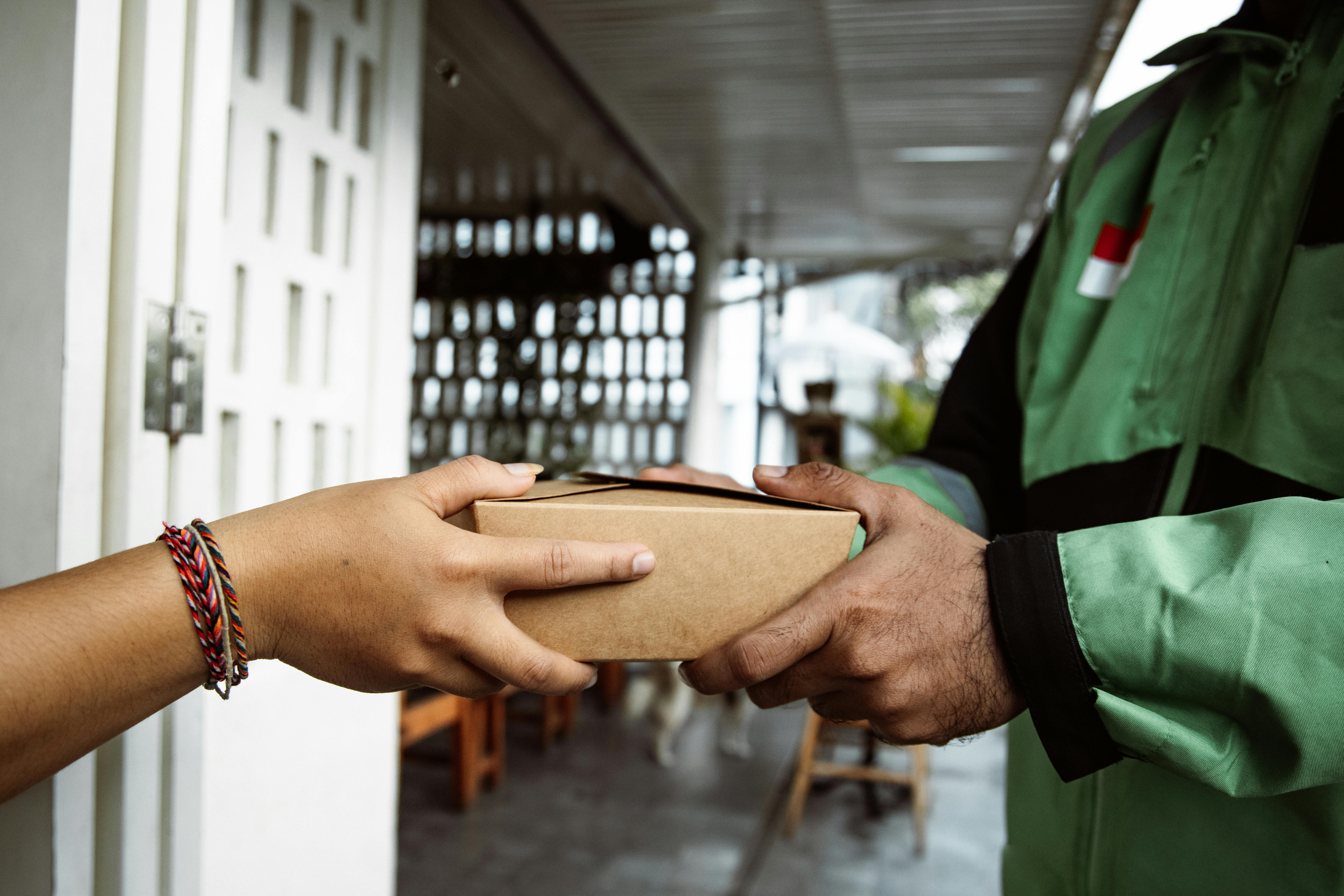 Close Up Shot of a Person Delivering a Small Box