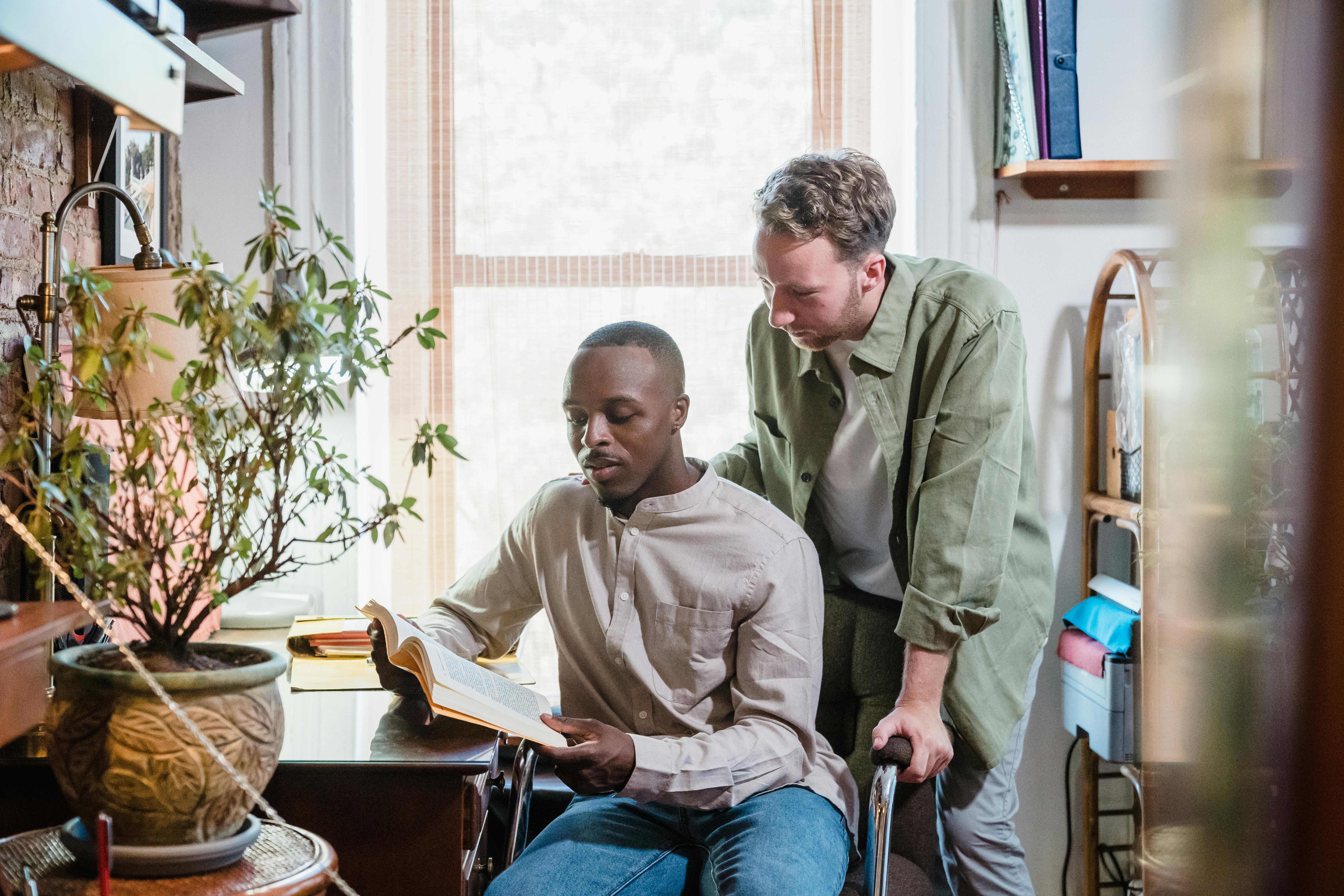 A Man Sitting at a Desk with a Book