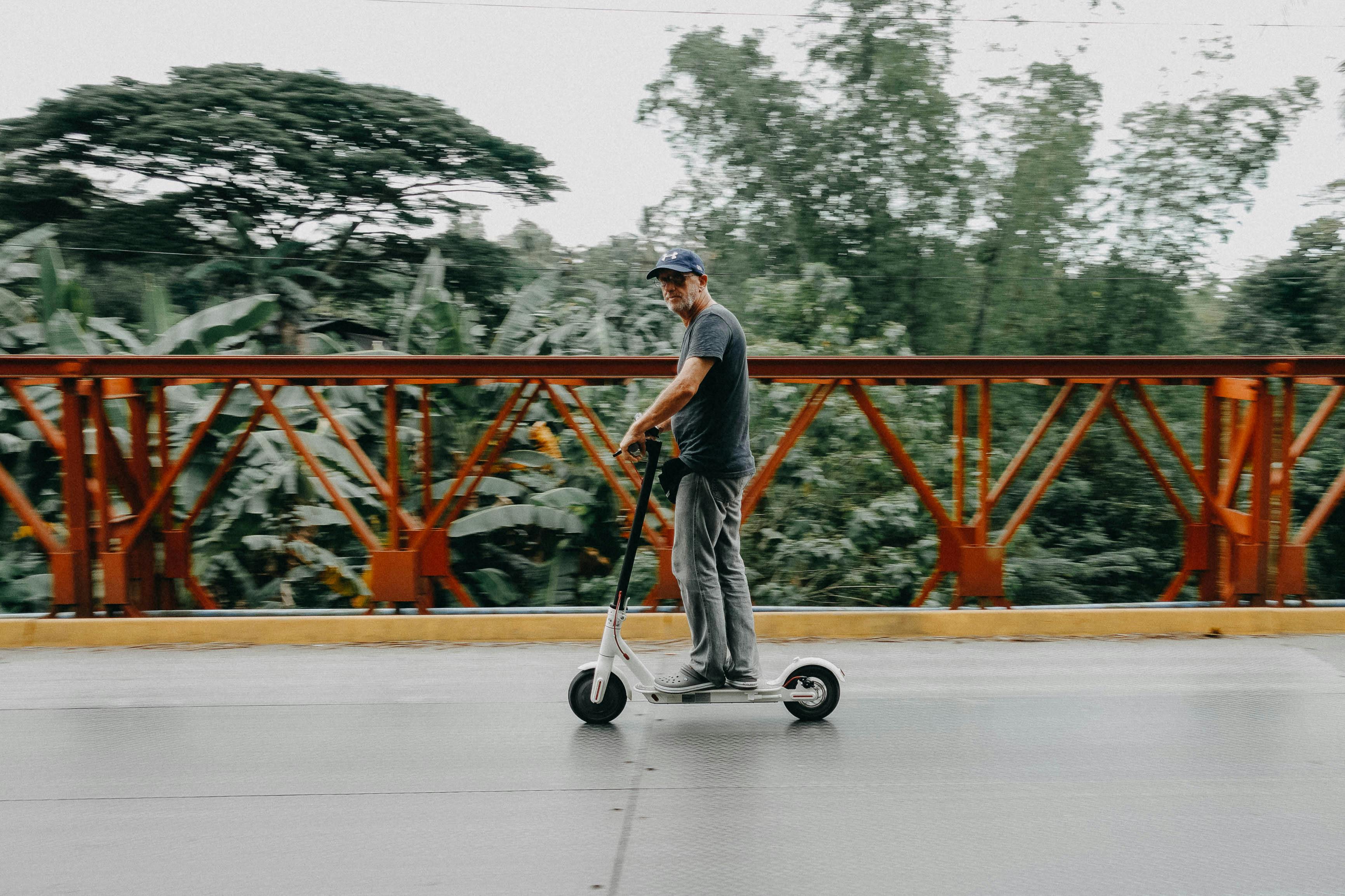 Man Riding on Bird Electric Scooter