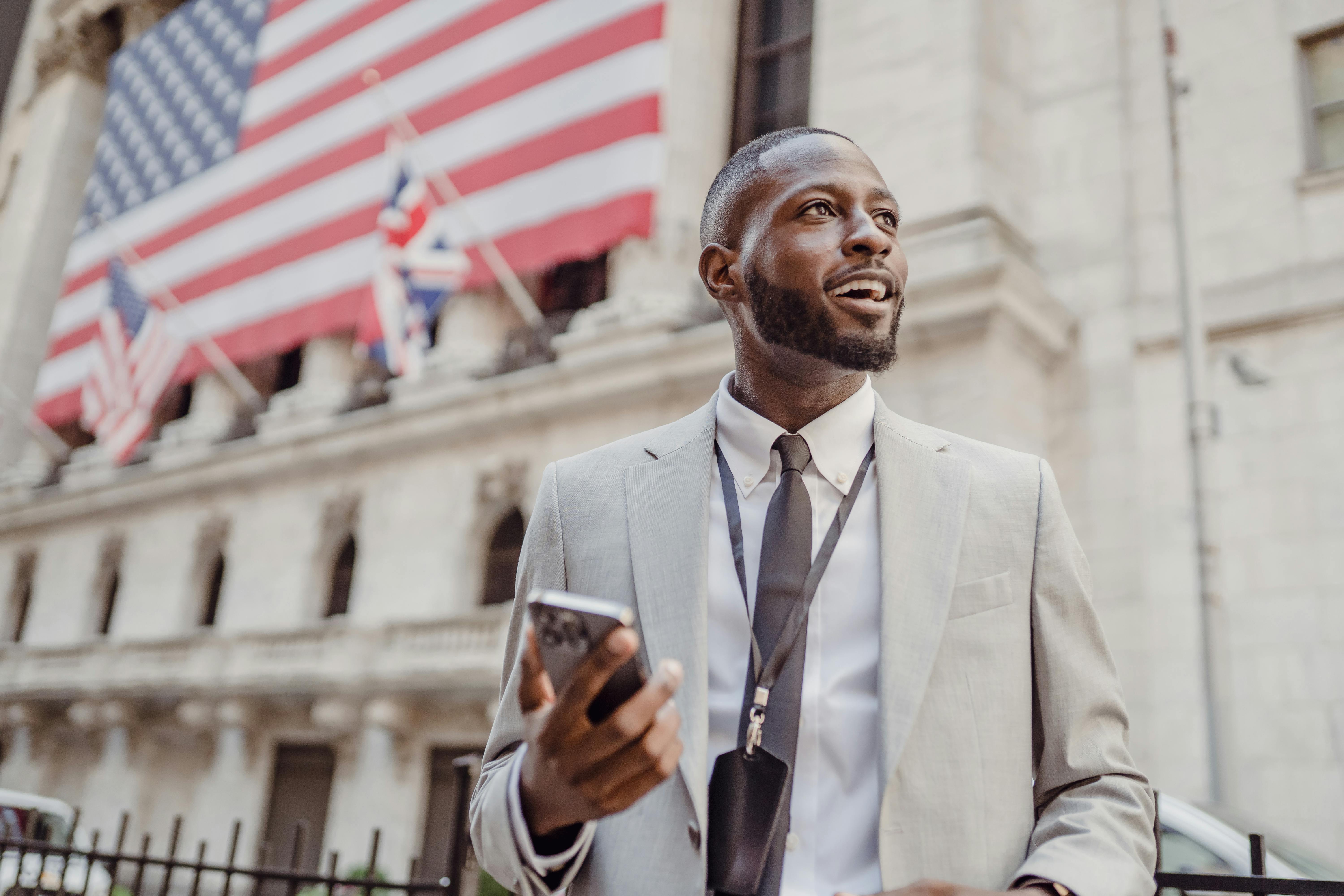 Man Standing in the Street with a Phone in his Hand