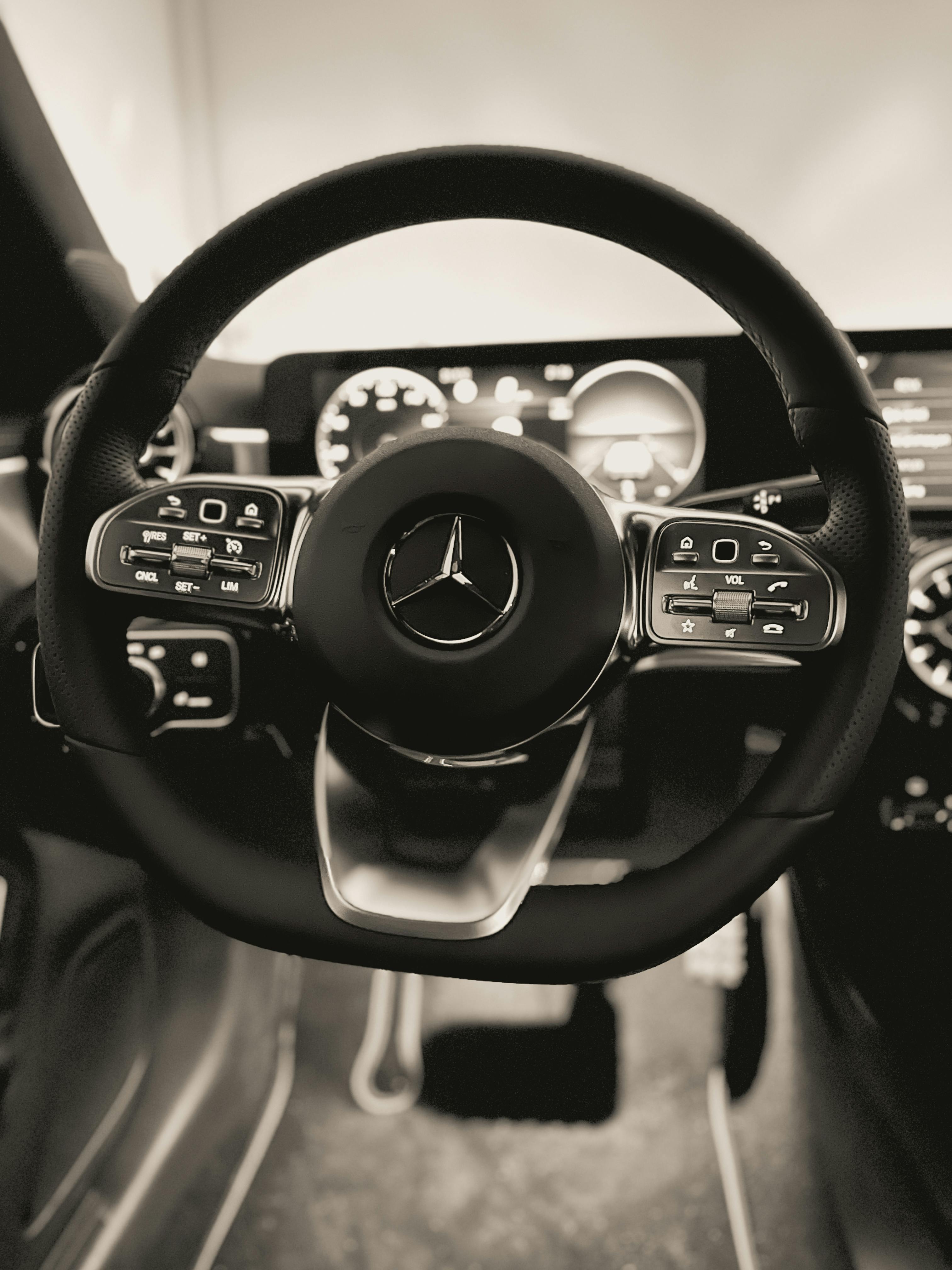 Grayscale Photo of a Mercedes Benz Steering Wheel