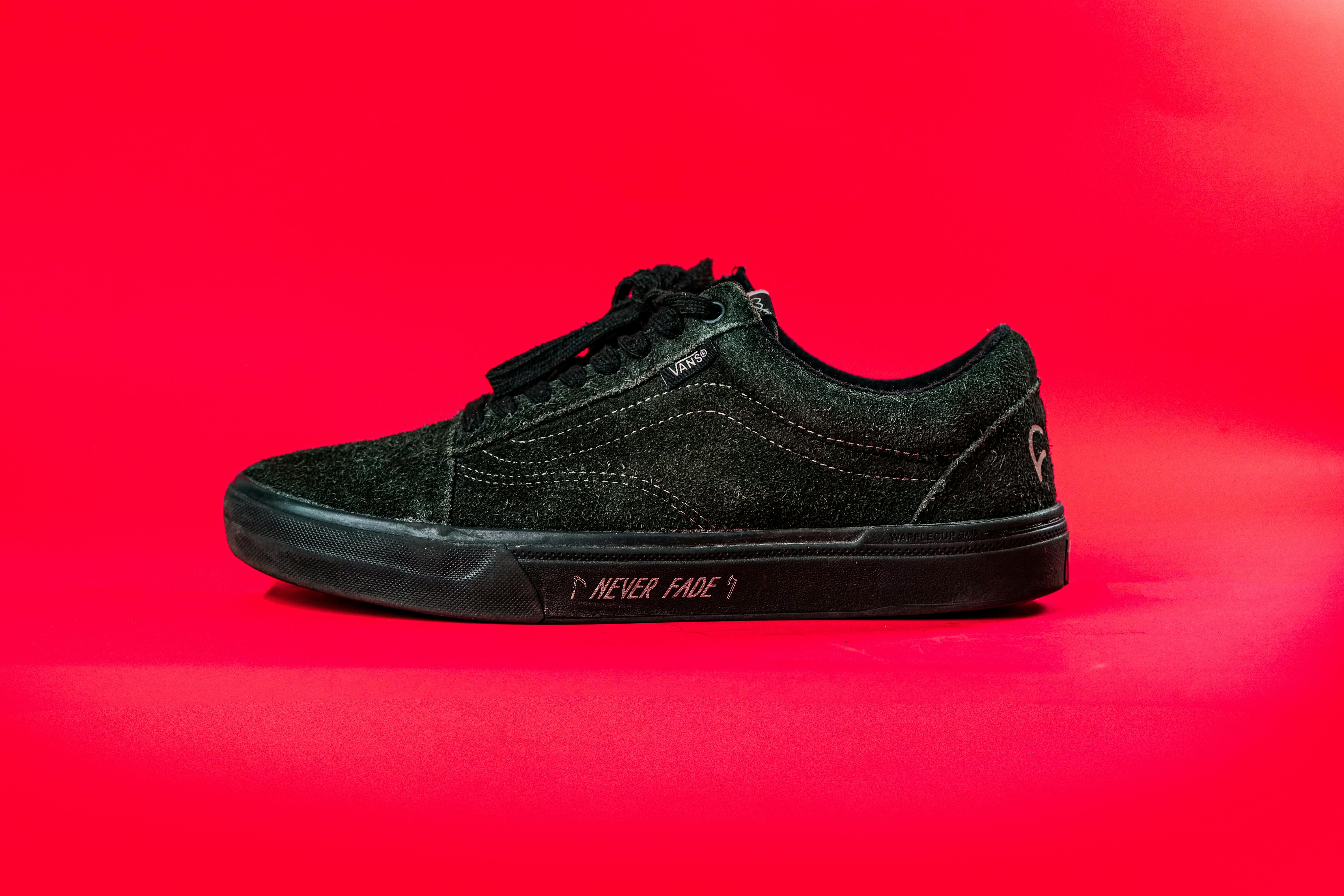 Black Vans Velvet Shoe on Pink Surface