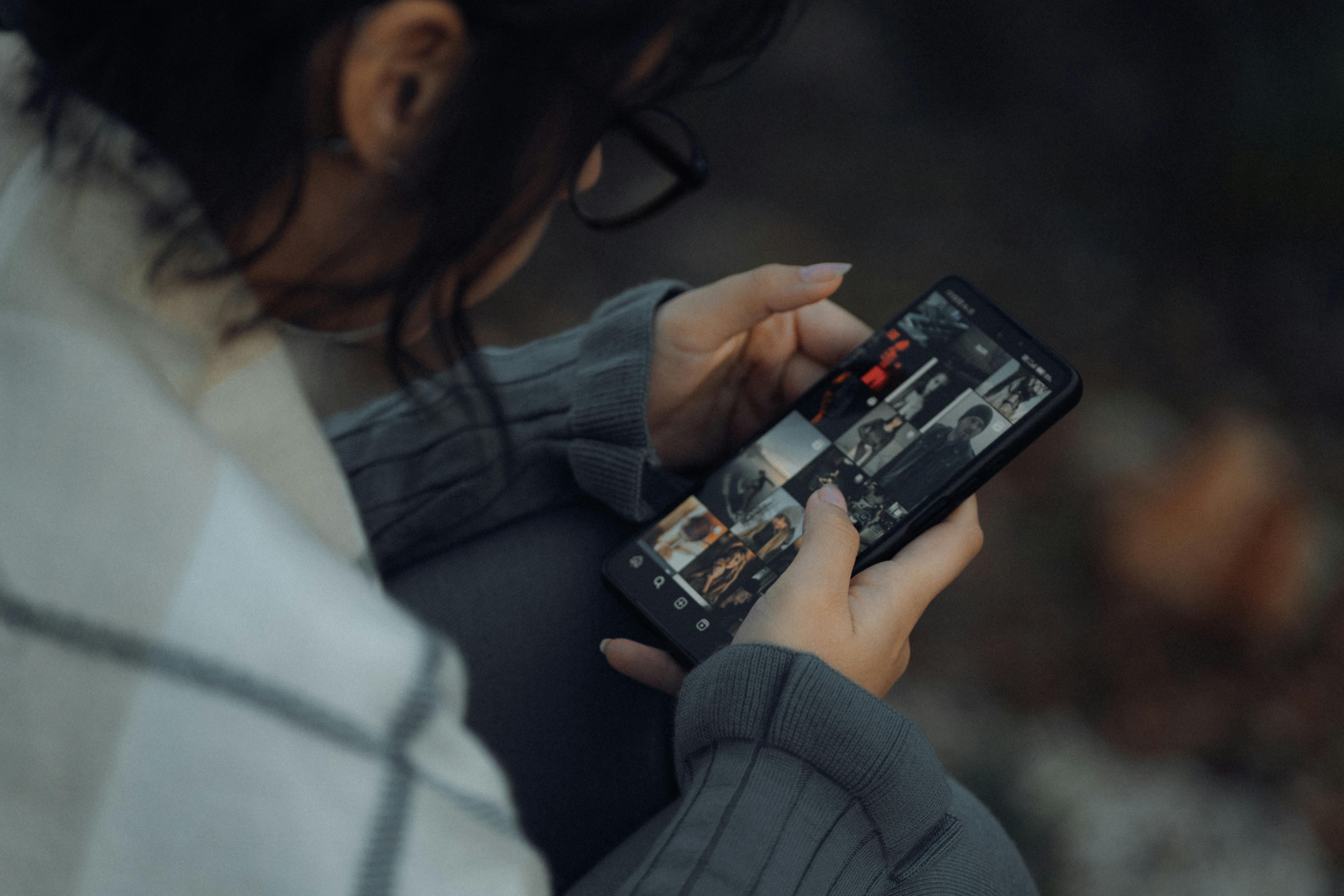 Girl Looking at Photo Gallery in Smartphone