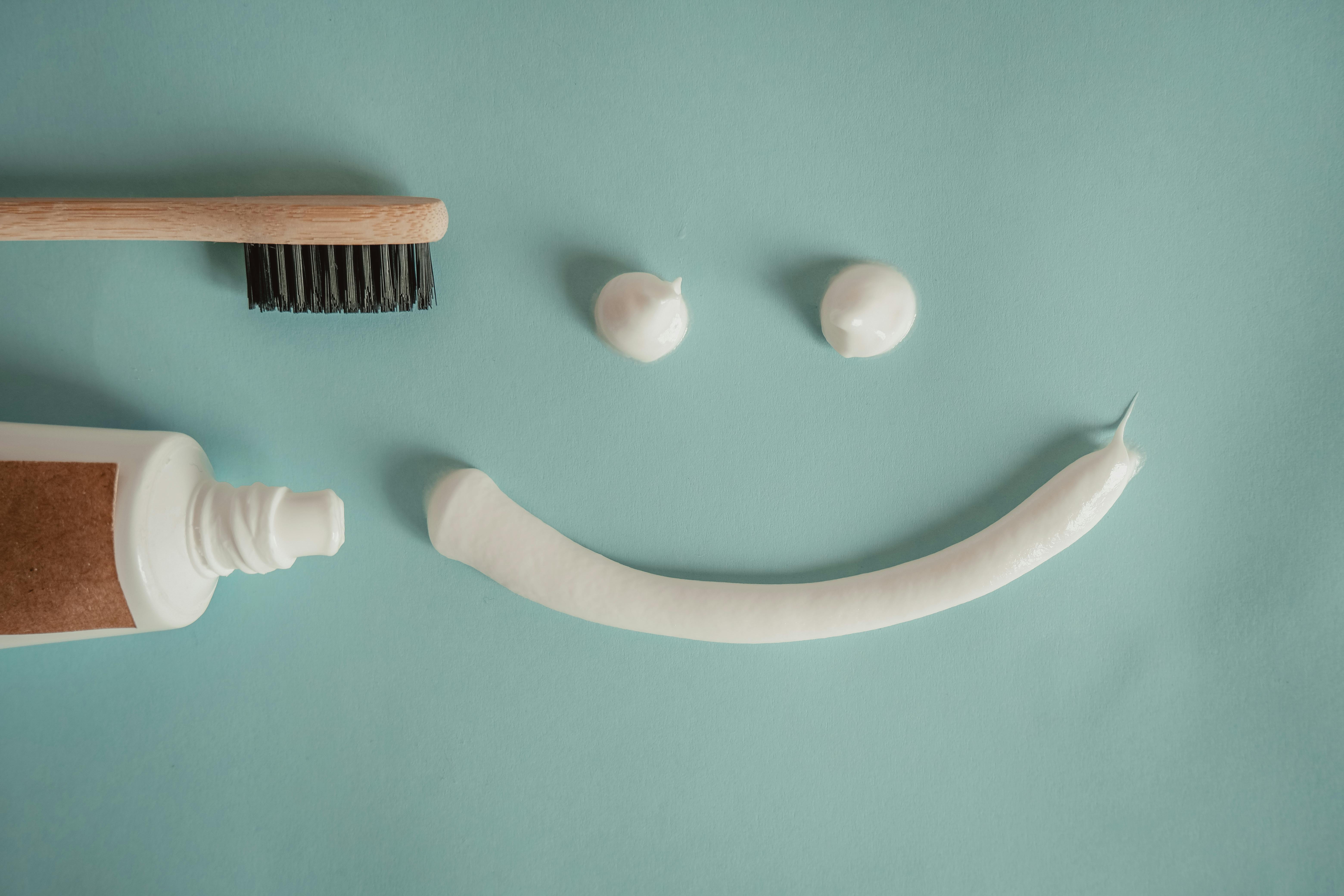 Toothbrush, a a Tube of Toothpaste and a Smile Painted with Toothpaste