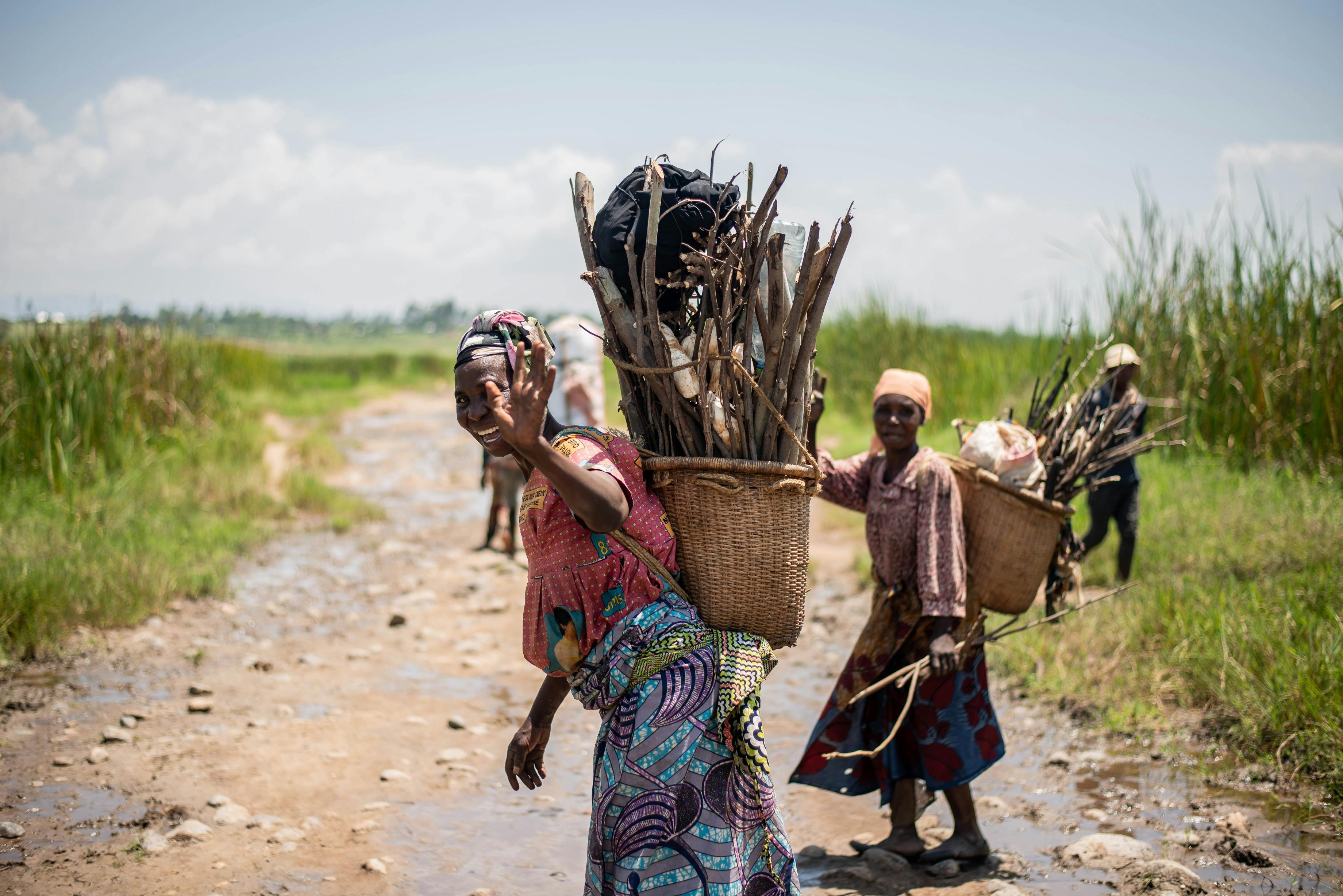 Women Carrying Wooden for Fuel in Basket on Back