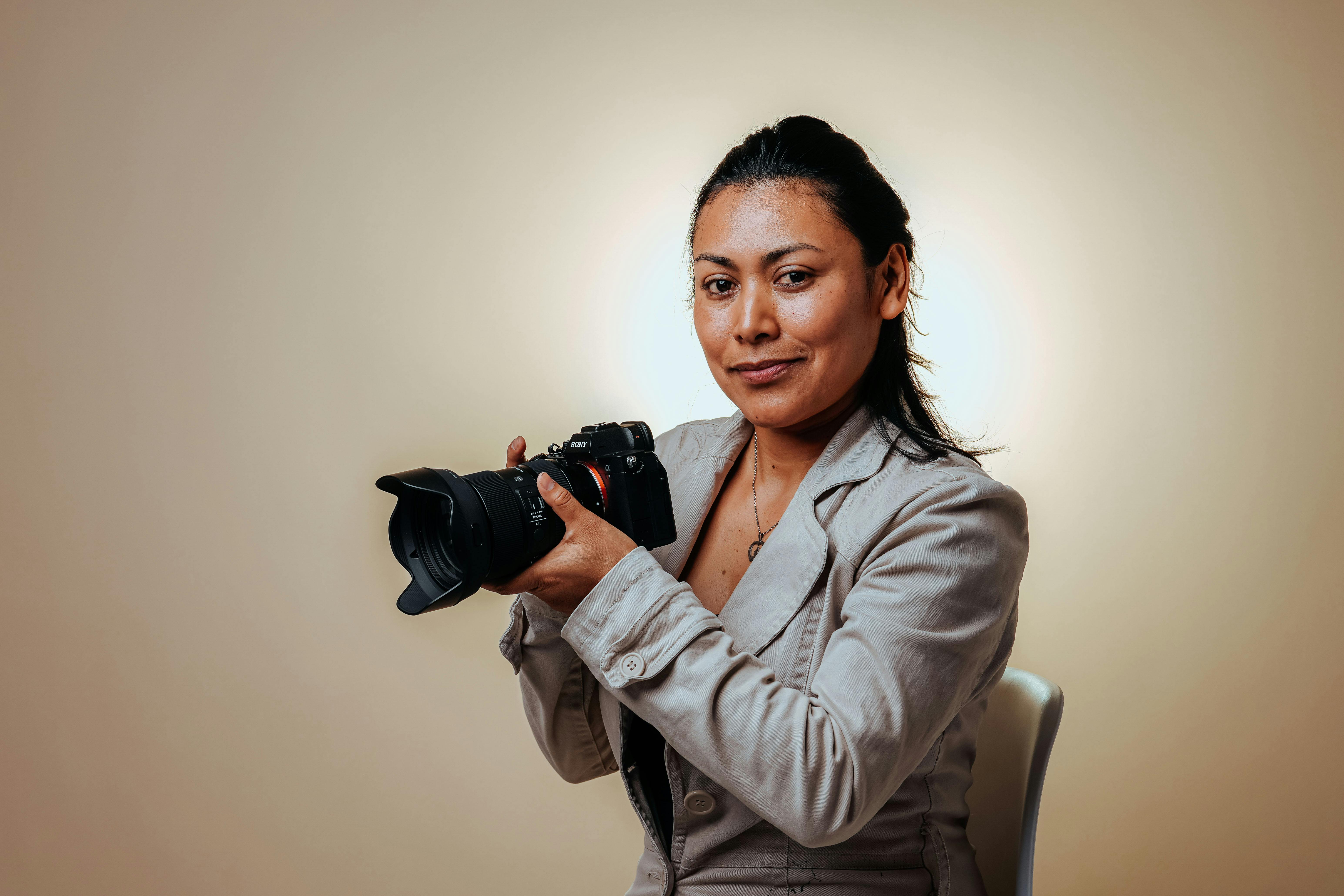 Woman in a Jacket Holding a Camera
