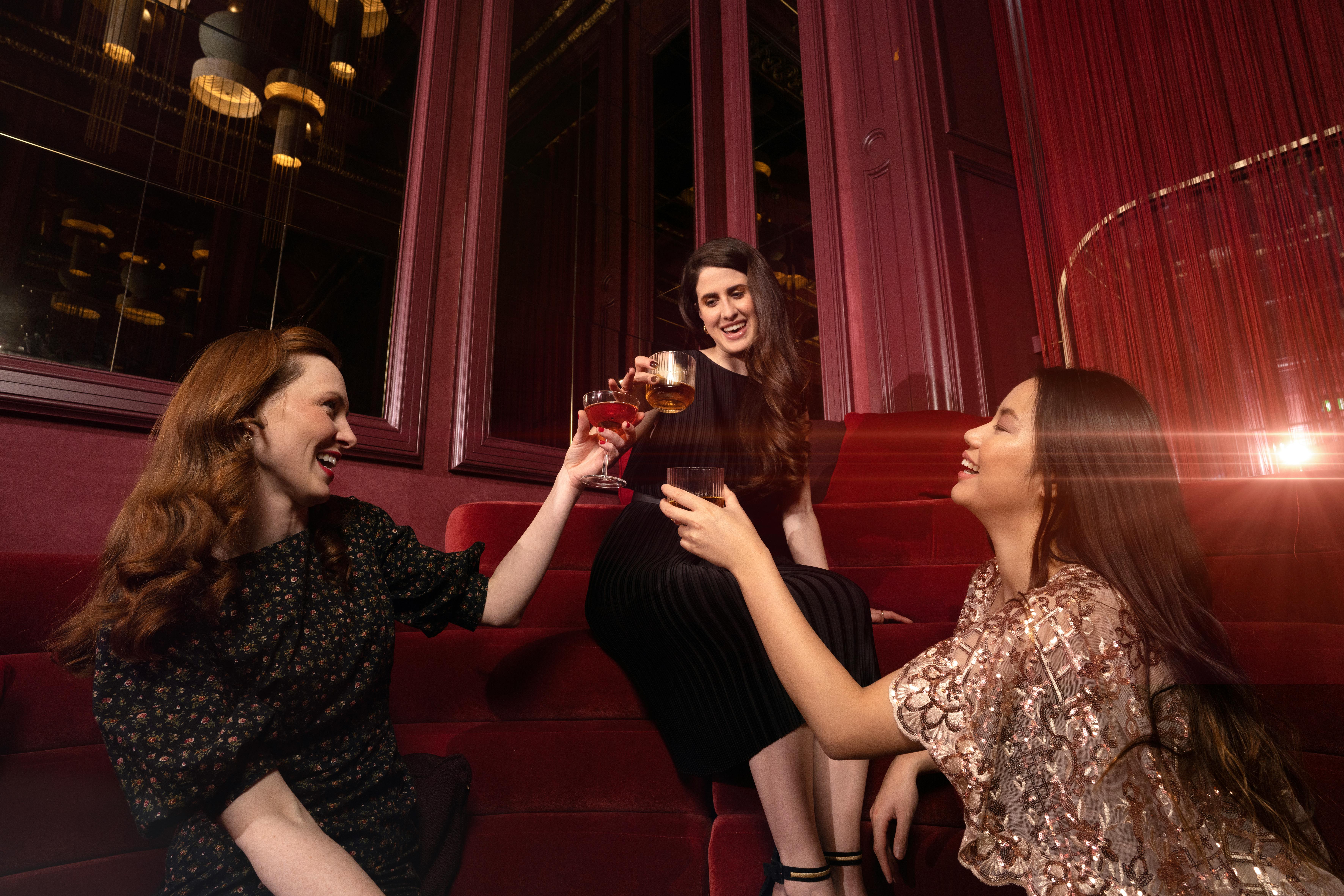 Three Brunettes Toasting in a Bar