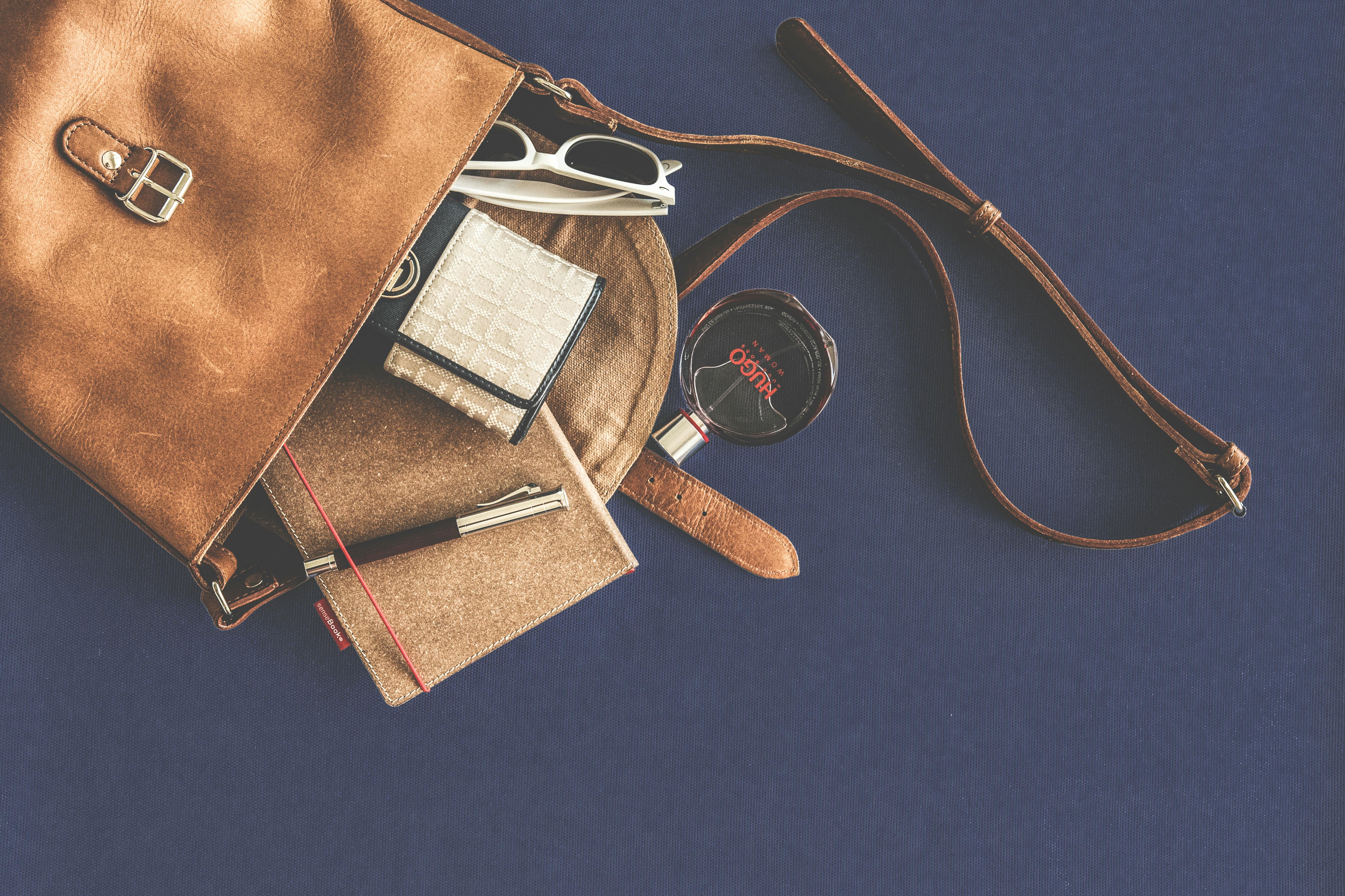 Brown Leather Crossbody Bag With White Framed Sunglasses