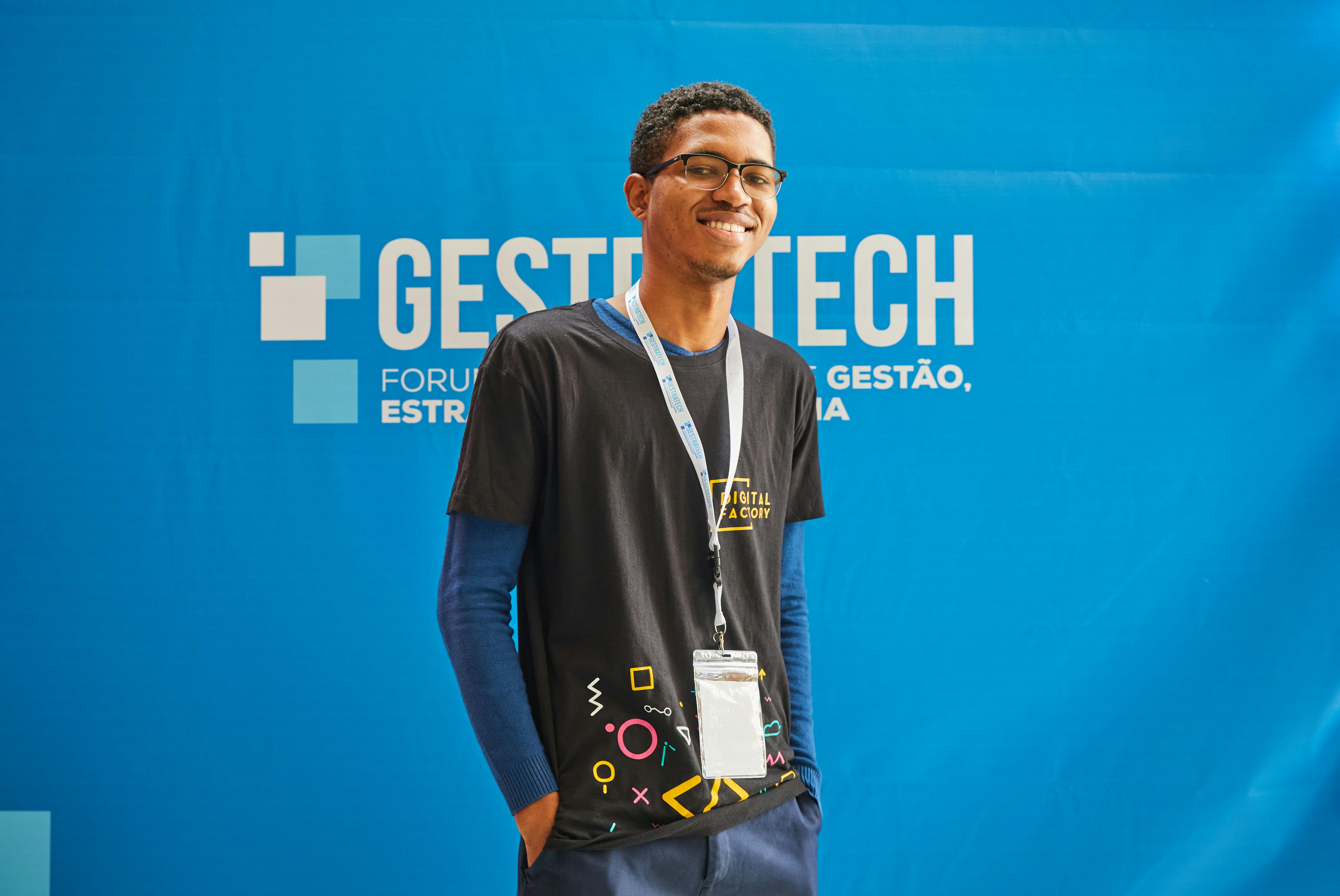 Smiling Young Man in T-Shirt at Business Conference