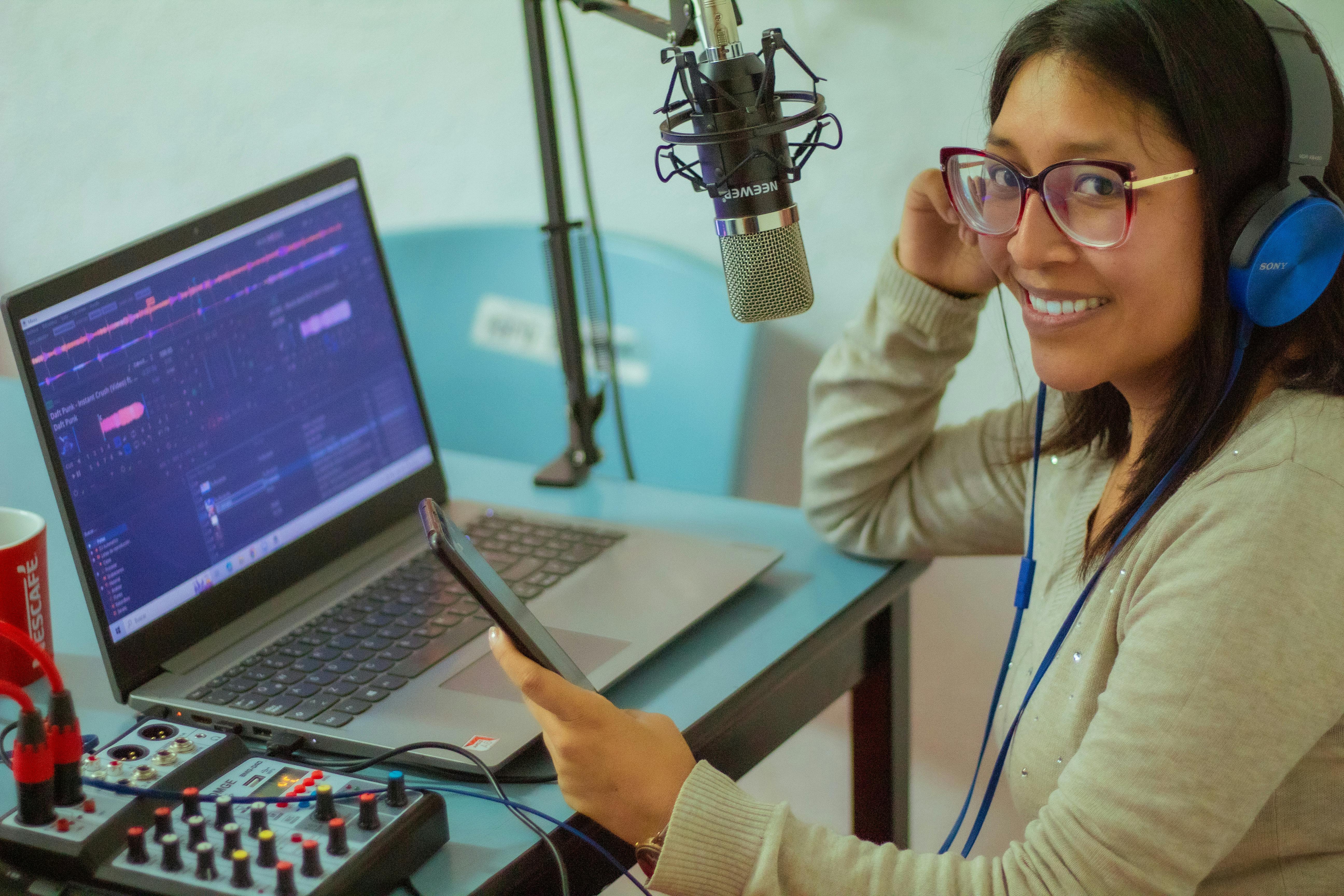 Smiling Woman Working with Laptop and Microphone