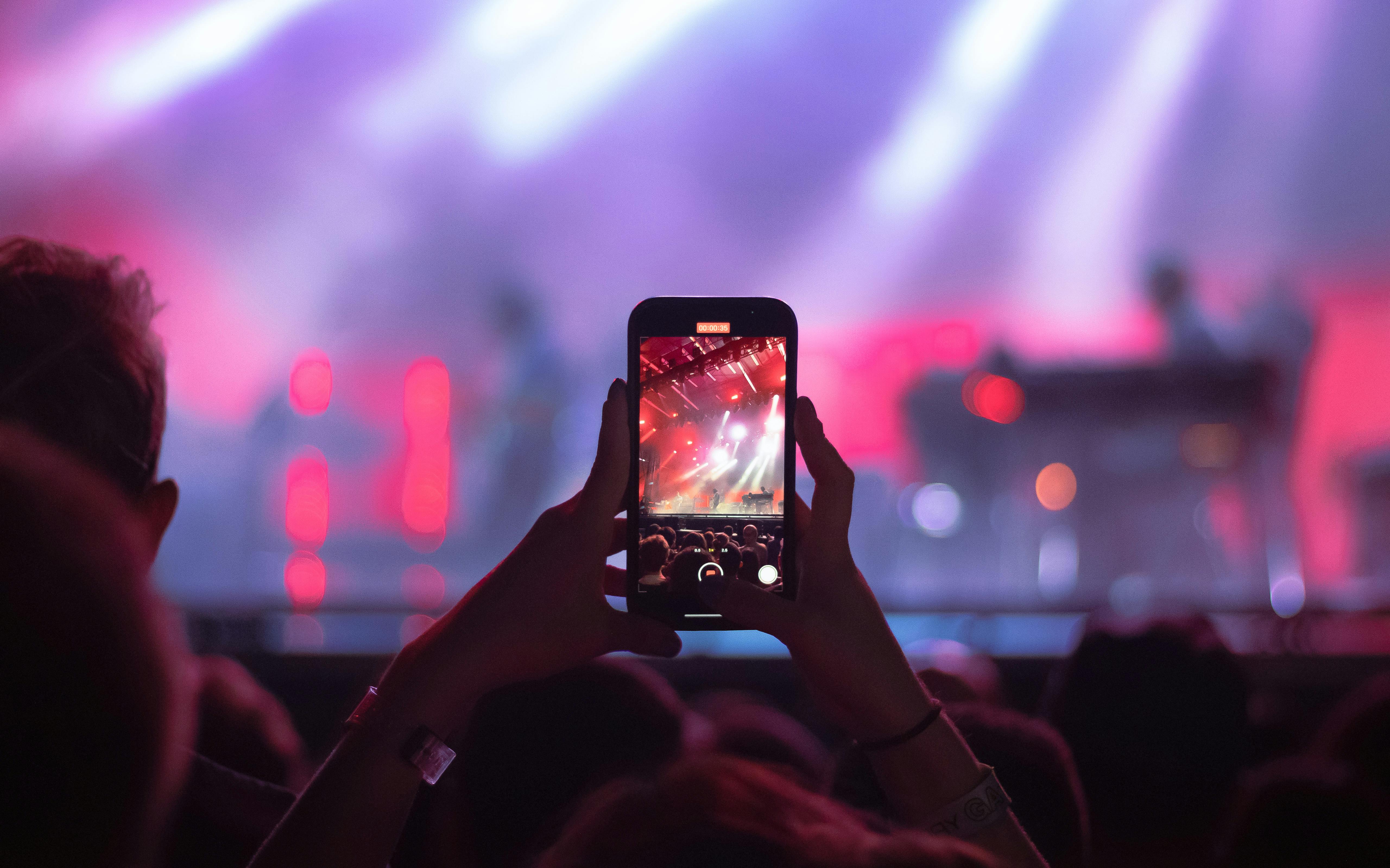 A Person Holding a Smartphone at a Concert