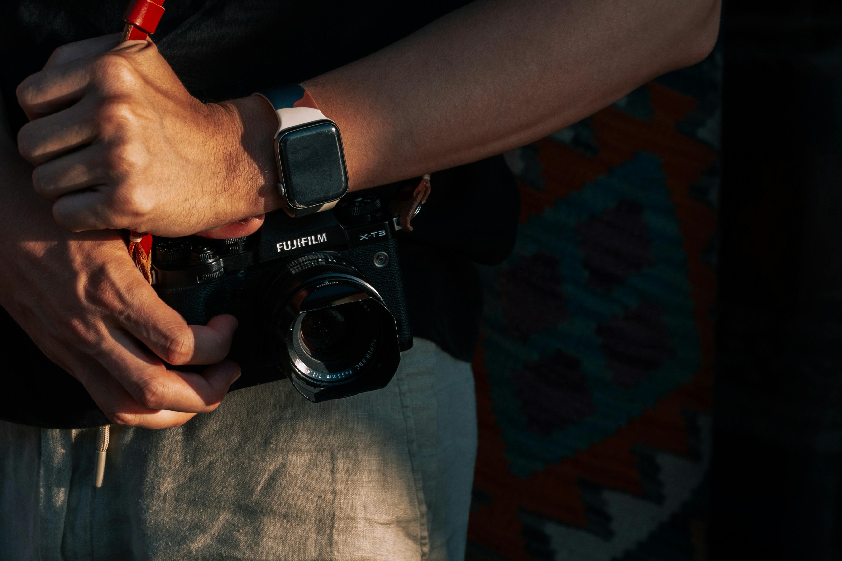 Close-up of a Camera in Photographers Hands