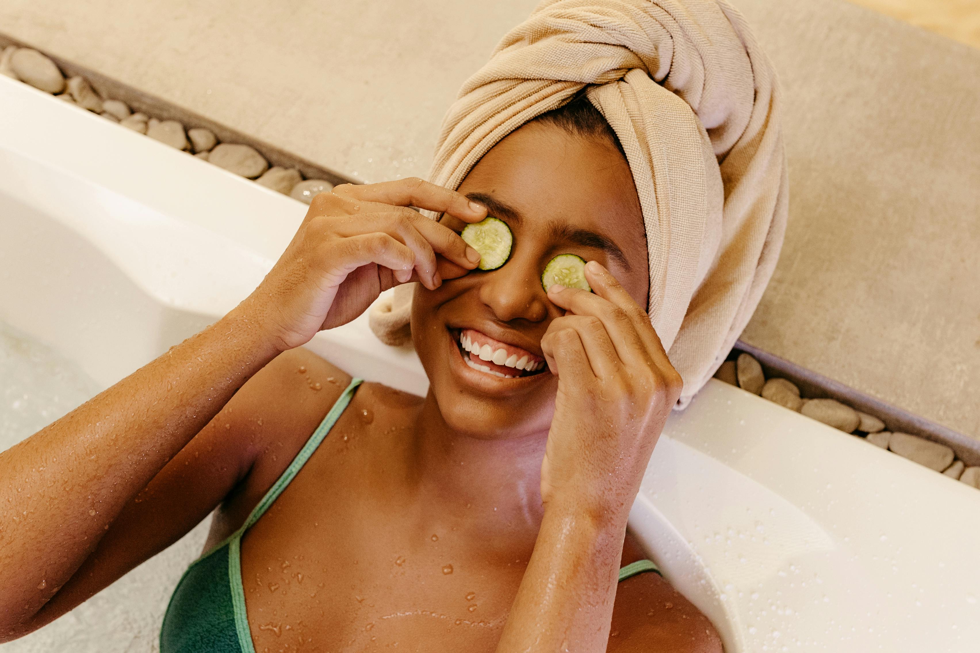 Woman with Cucumber Slices on her Eyes Lying in a Bathtub