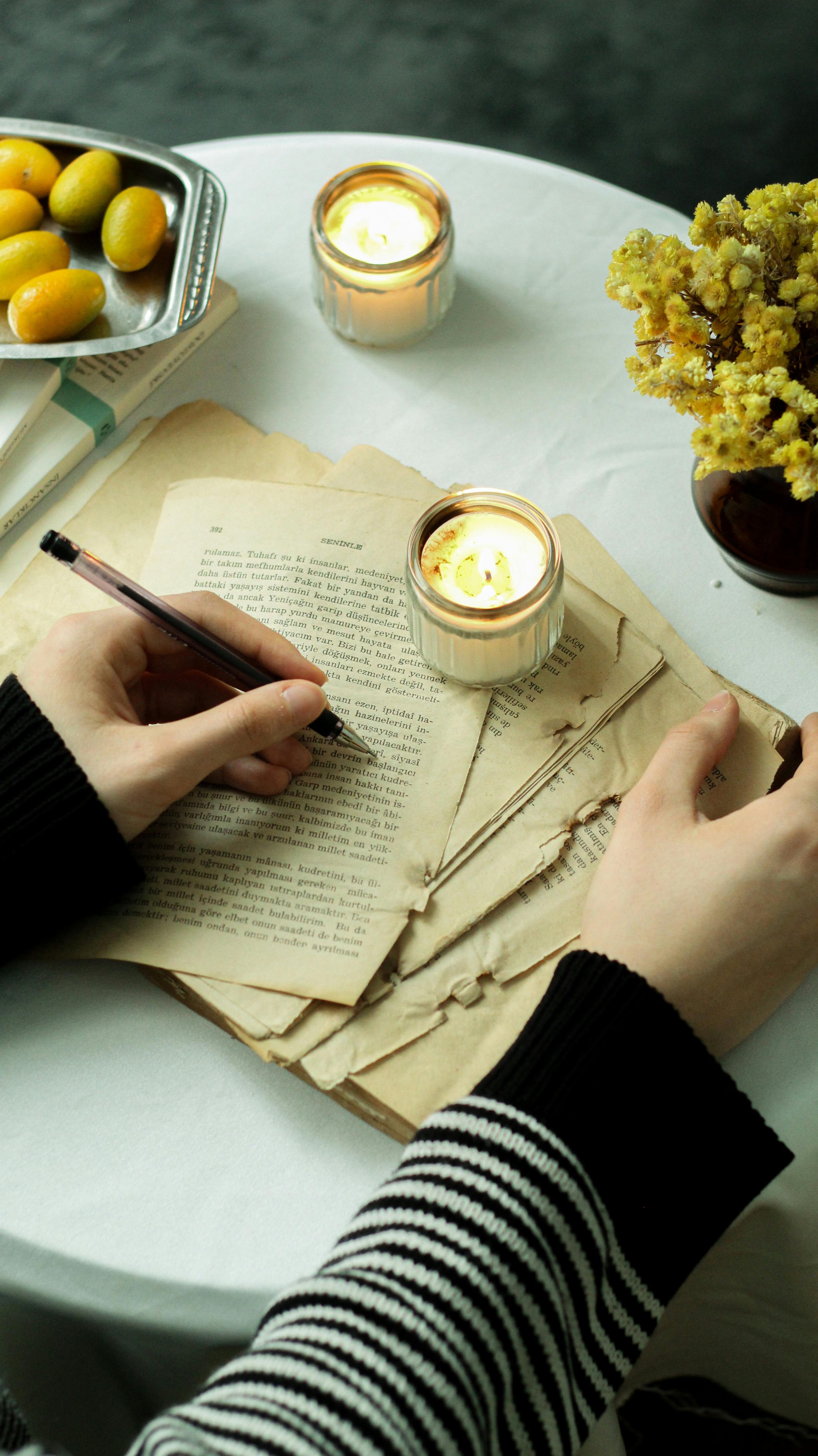 Woman Hands on Torn Book Pages
