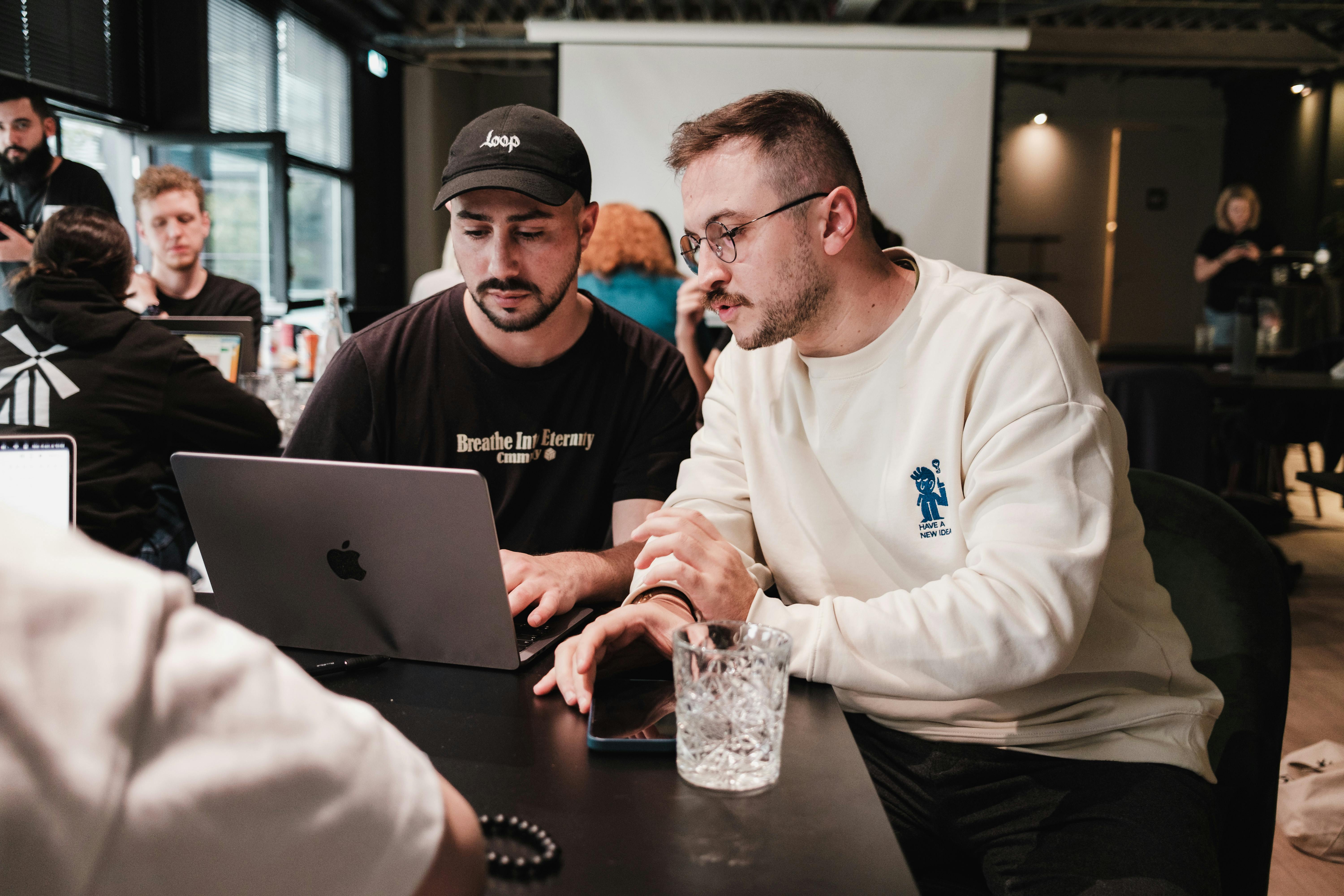 Men Working on Laptop on Table